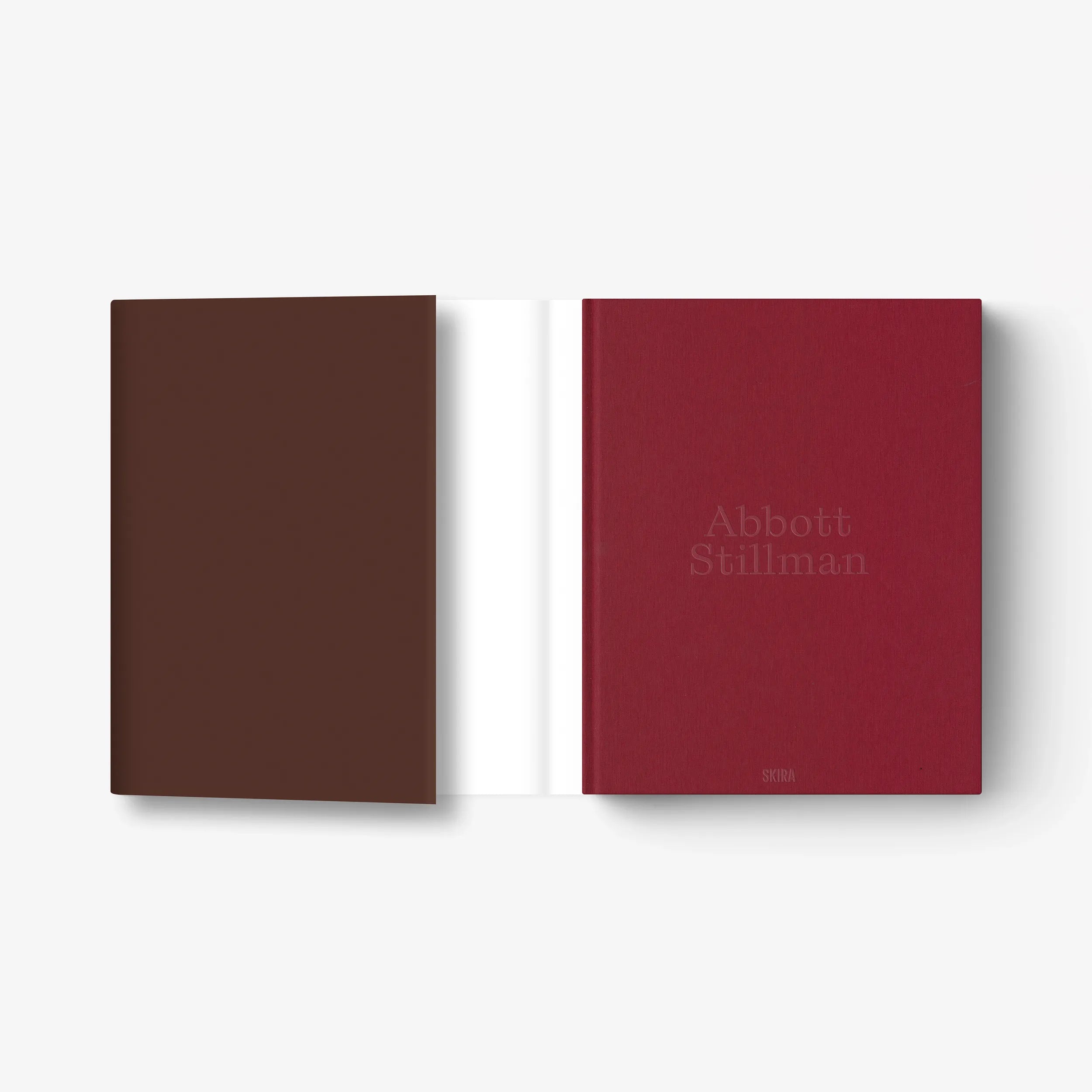 Art book with brown and burgundy covers, title text on right cover