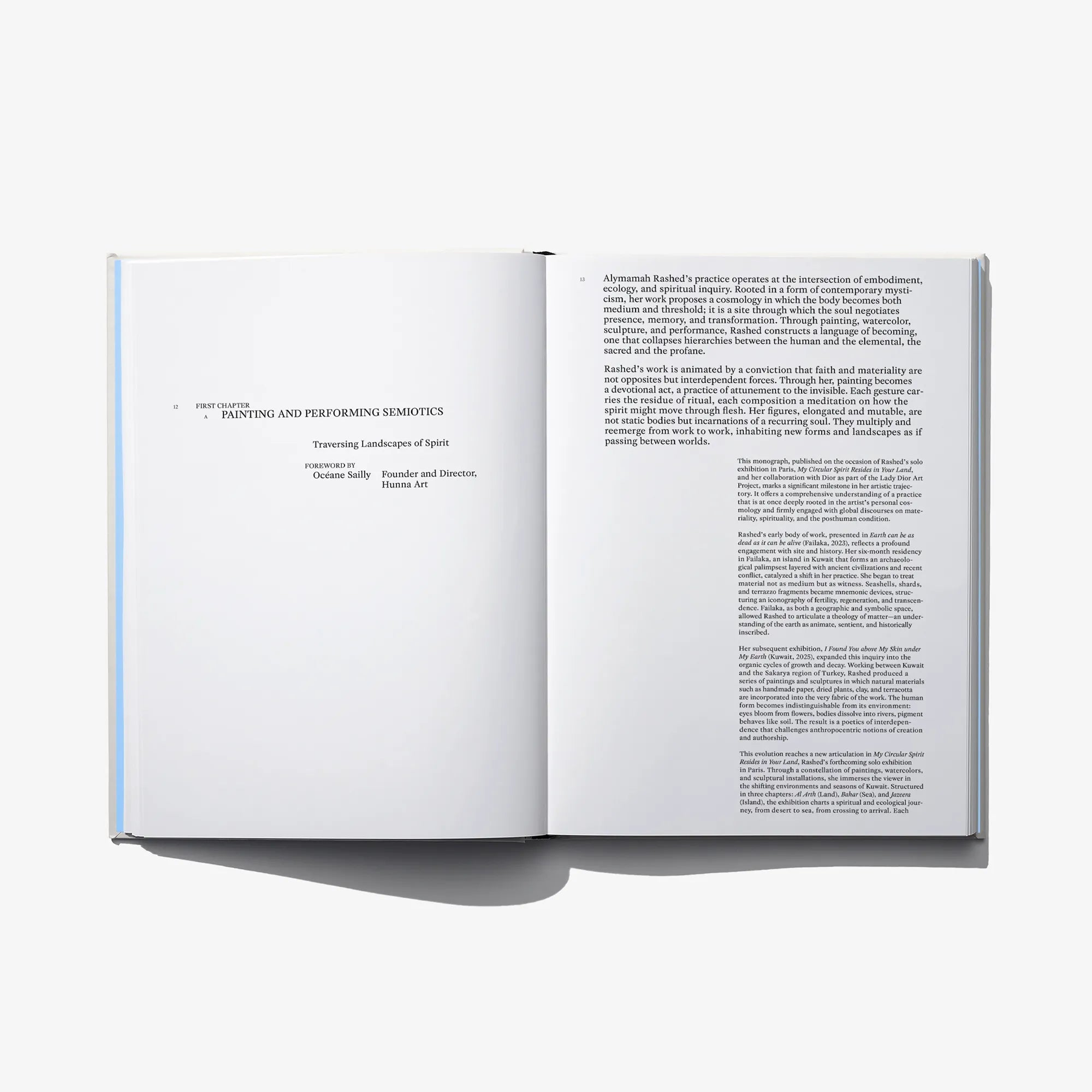 Open hardcover art book spread with paragraphs and blocks of text