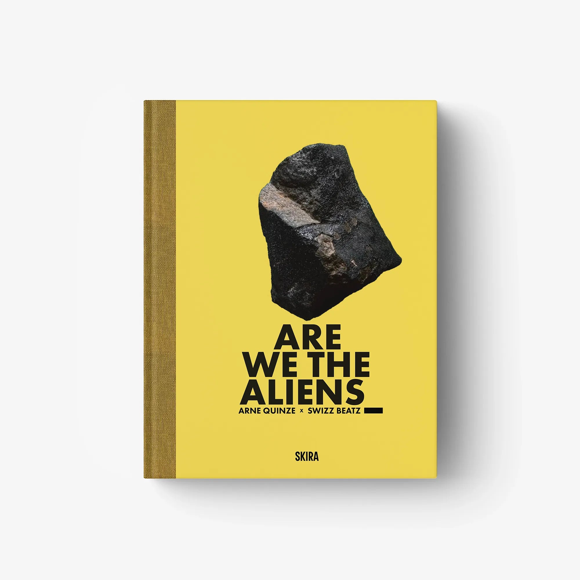 Yellow hardcover book with black title text and abstract stone image on front cover