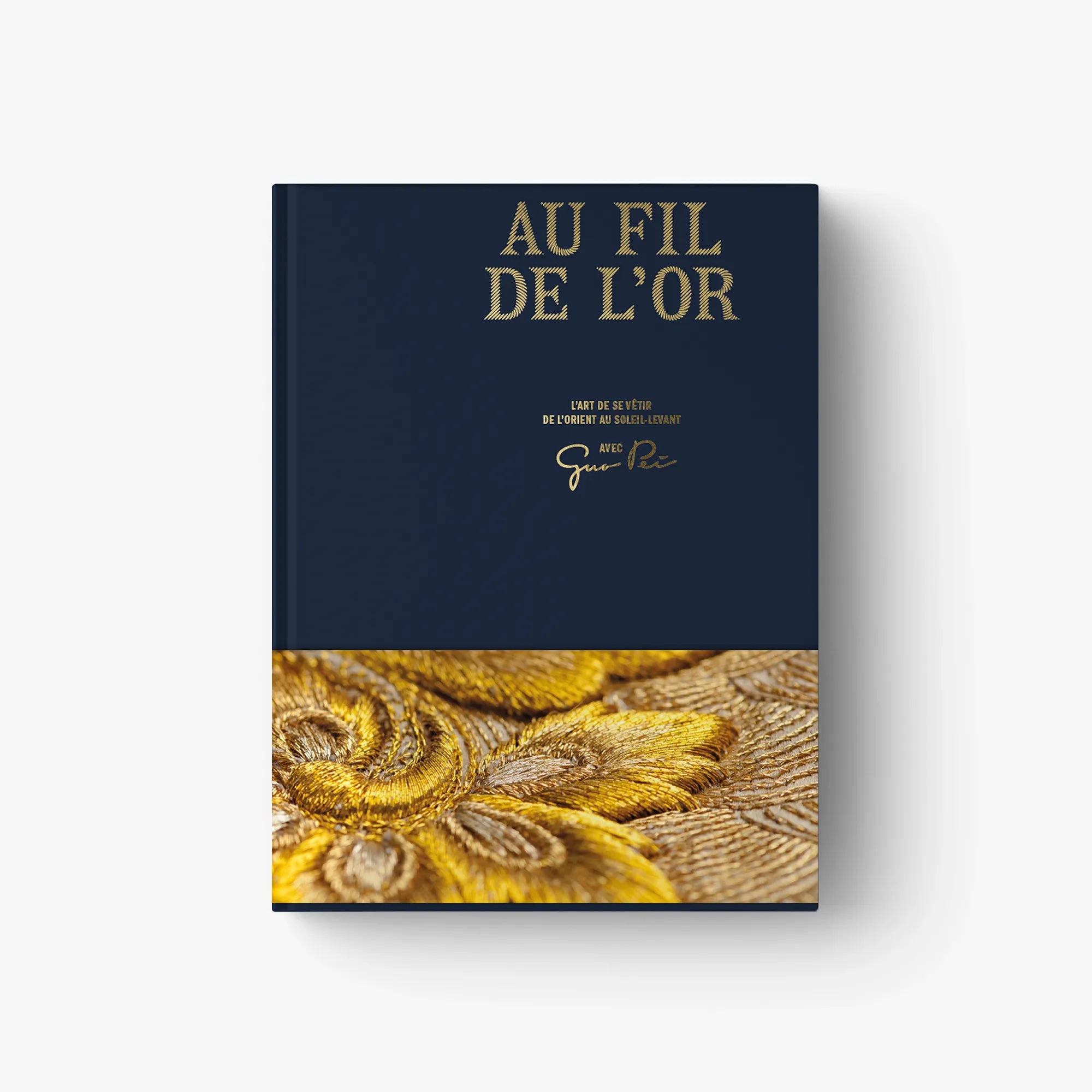 Au Fil de L'Or hardcover book cover with gold embroidery close-up