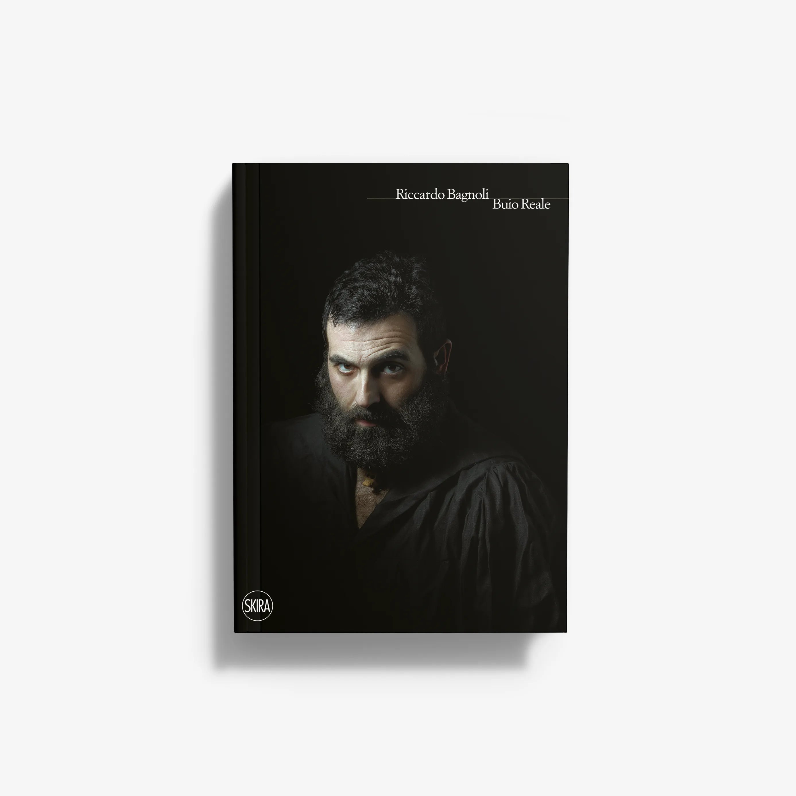 Hardcover book with dark cover and portrait of a bearded man
