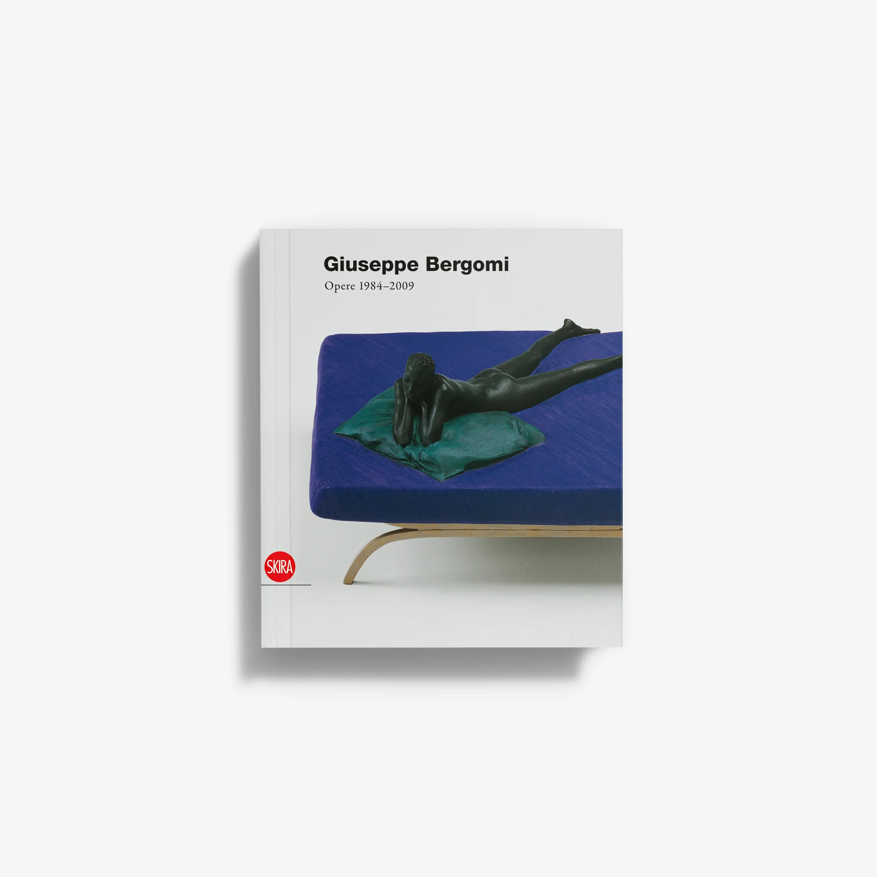 Art book with blue cover showing a reclining human figure and green fabric