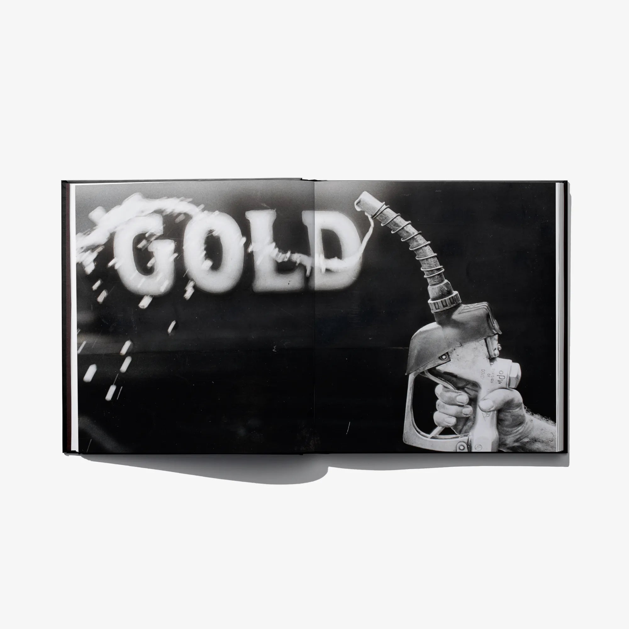 Open book cover panel with “GOLD” text and a hand holding a tool