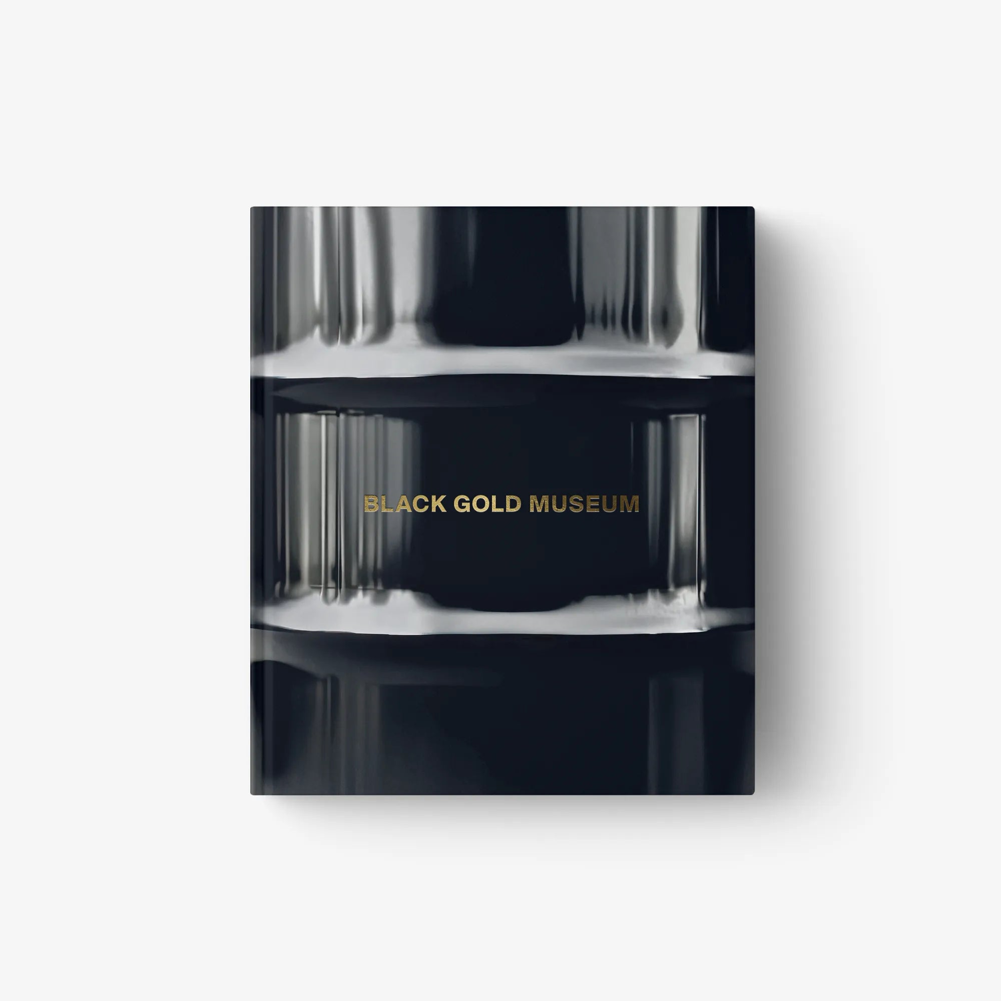 Hardcover art book cover with metallic blue-black finish and gold “BLACK GOLD MUSEUM” text