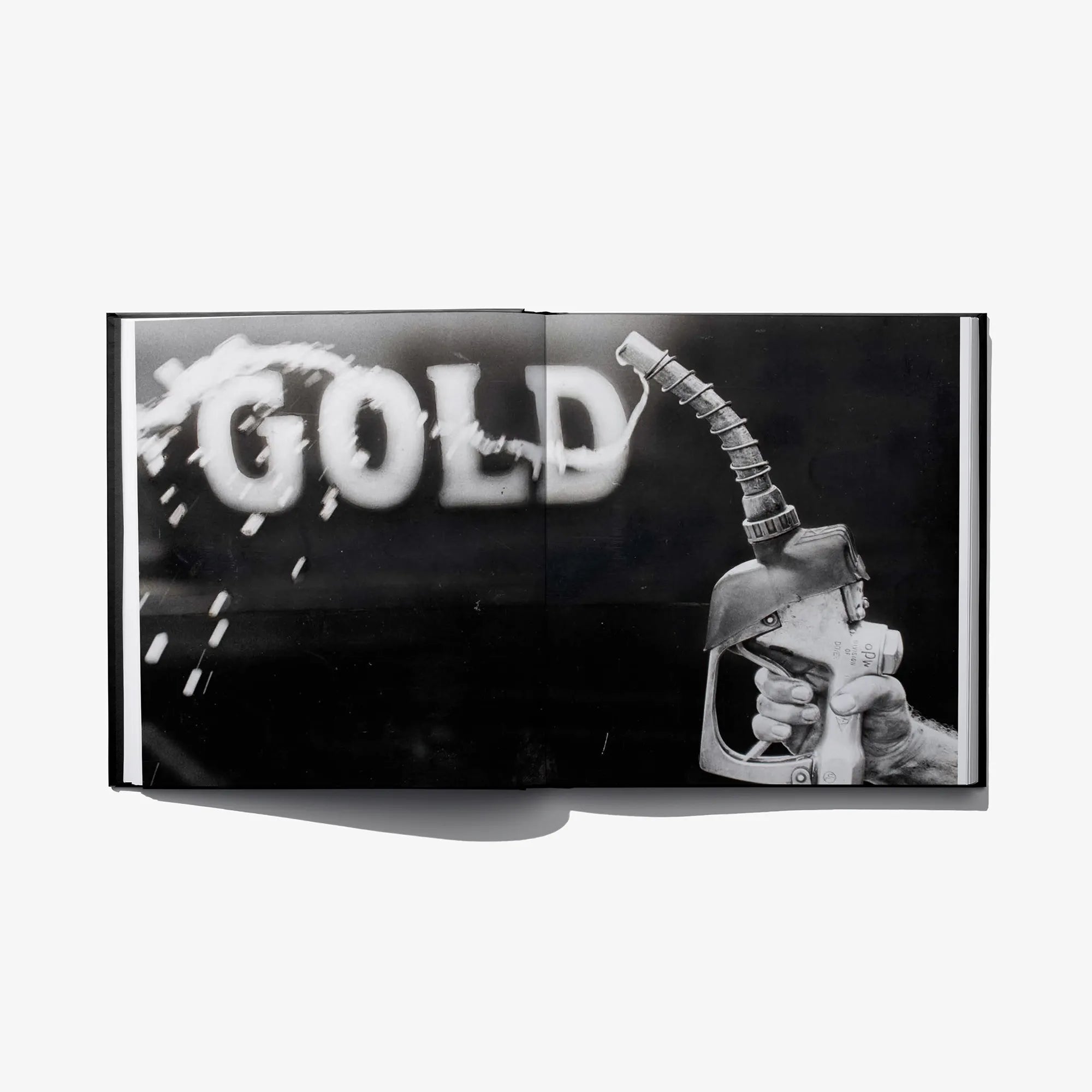 Hardcover art book with bold “GOLD” title and illustrated hand holding a pump