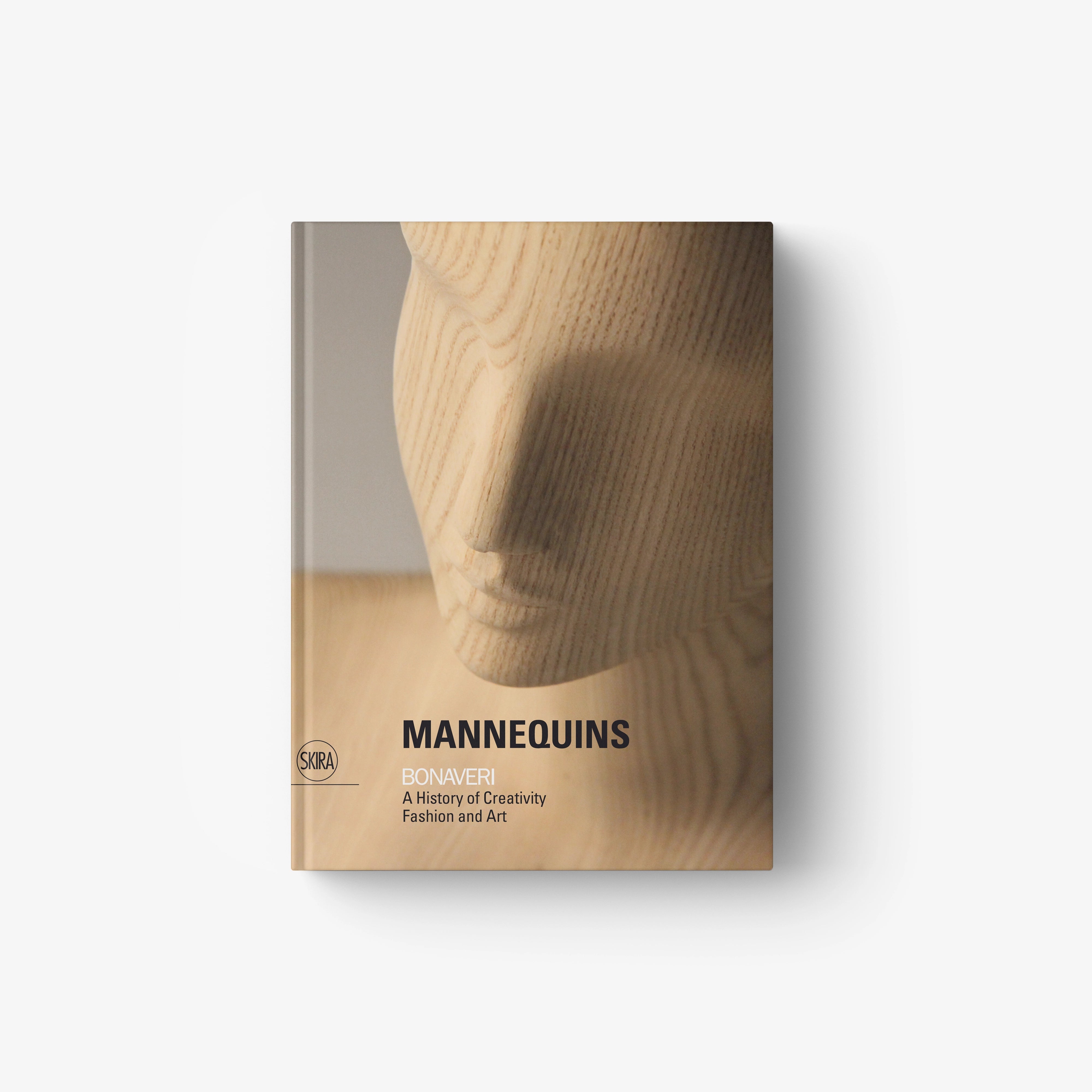 Fashion and art book with beige wood-grain cover and “MANNEQUINS” title
