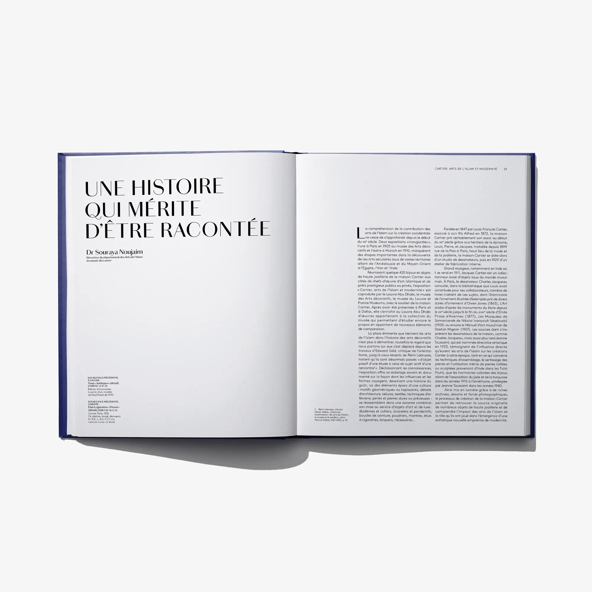 Open Cartier book showing a left heading and two-page French text spread