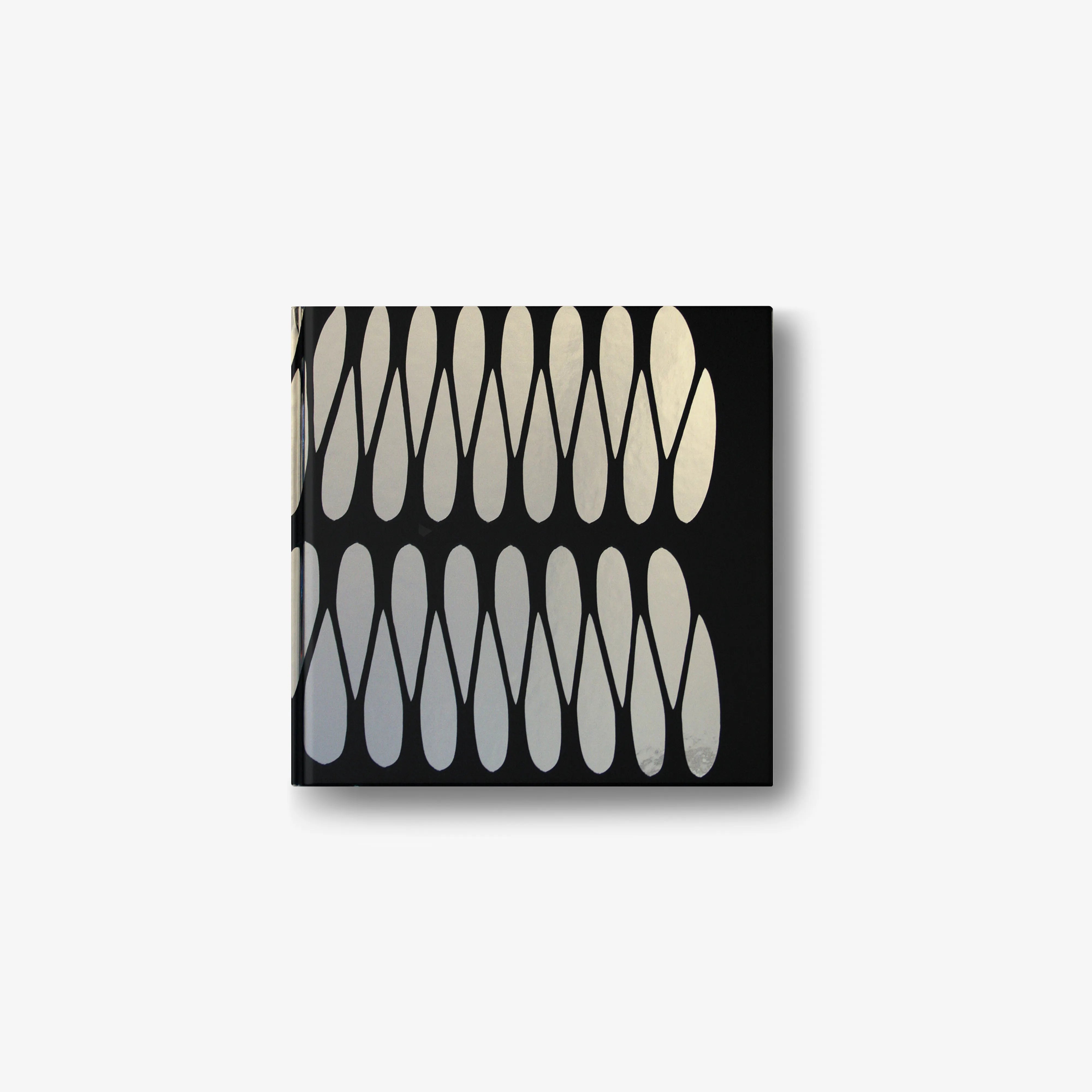 Emilio Cavallini English edition book with black cover and cream abstract arch shapes