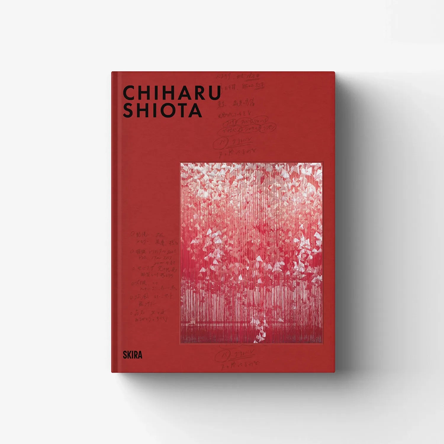 Red hardcover art book with CHIHARU SHIOTA title and abstract artwork cover