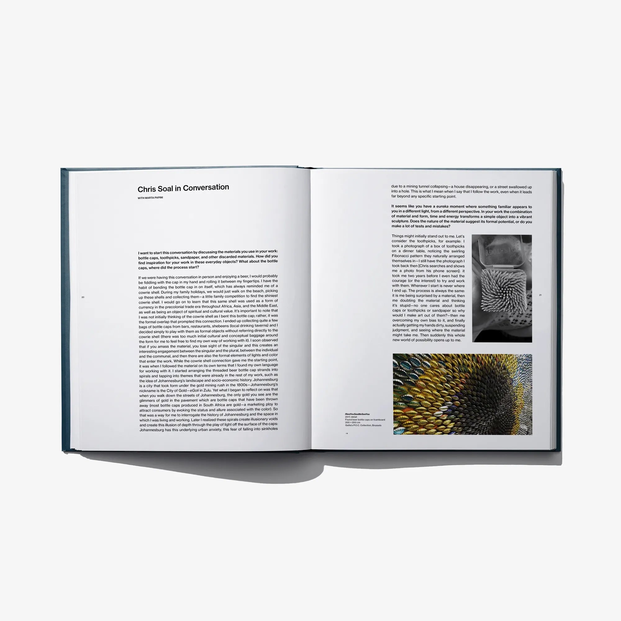 Open art book spread with printed text and small artwork photos on pages.