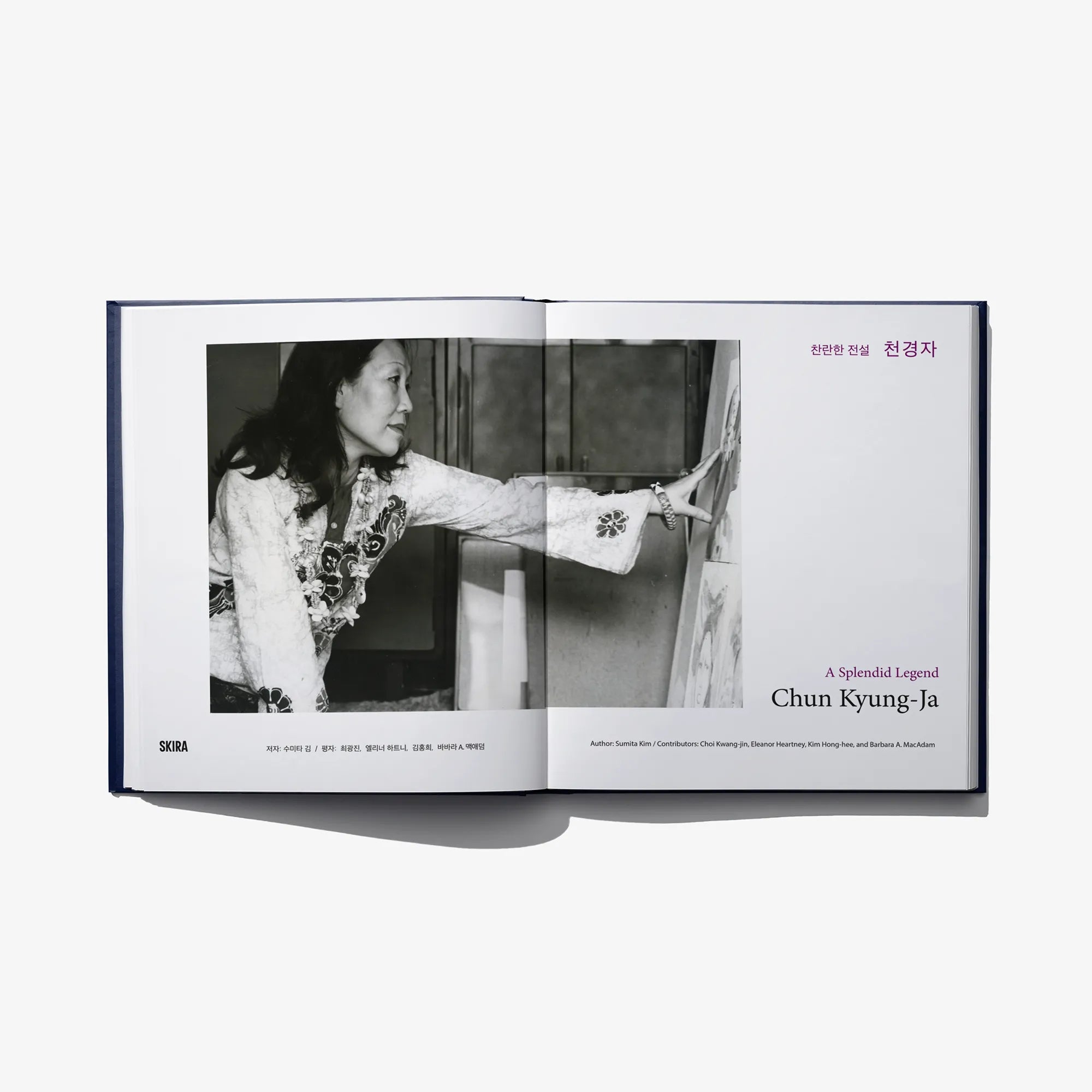 Open art book spread with black-and-white photo of a woman at work and printed text