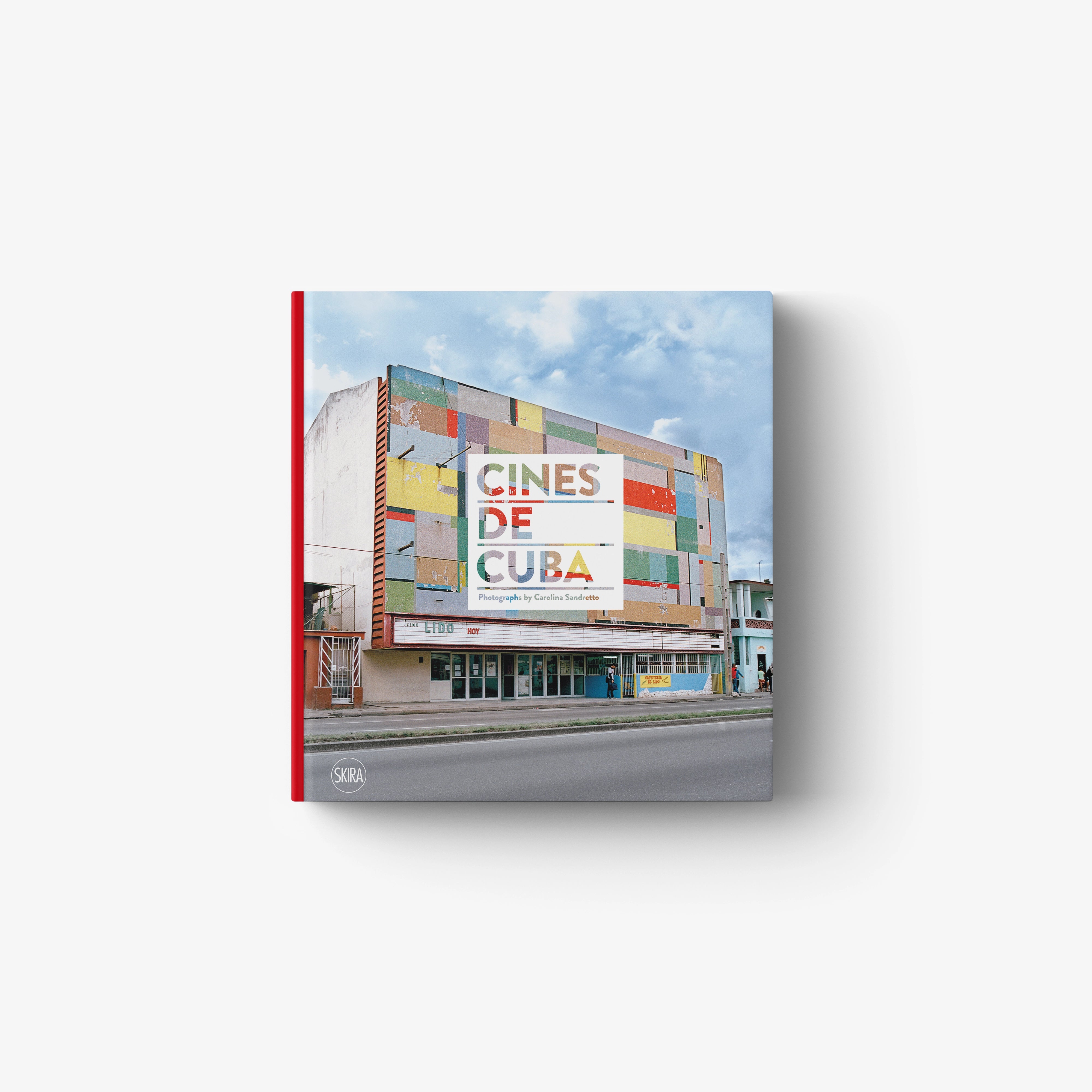 Hardcover book with red spine featuring a colorful Cuban cinema building on the cover under a partly cloudy sky.