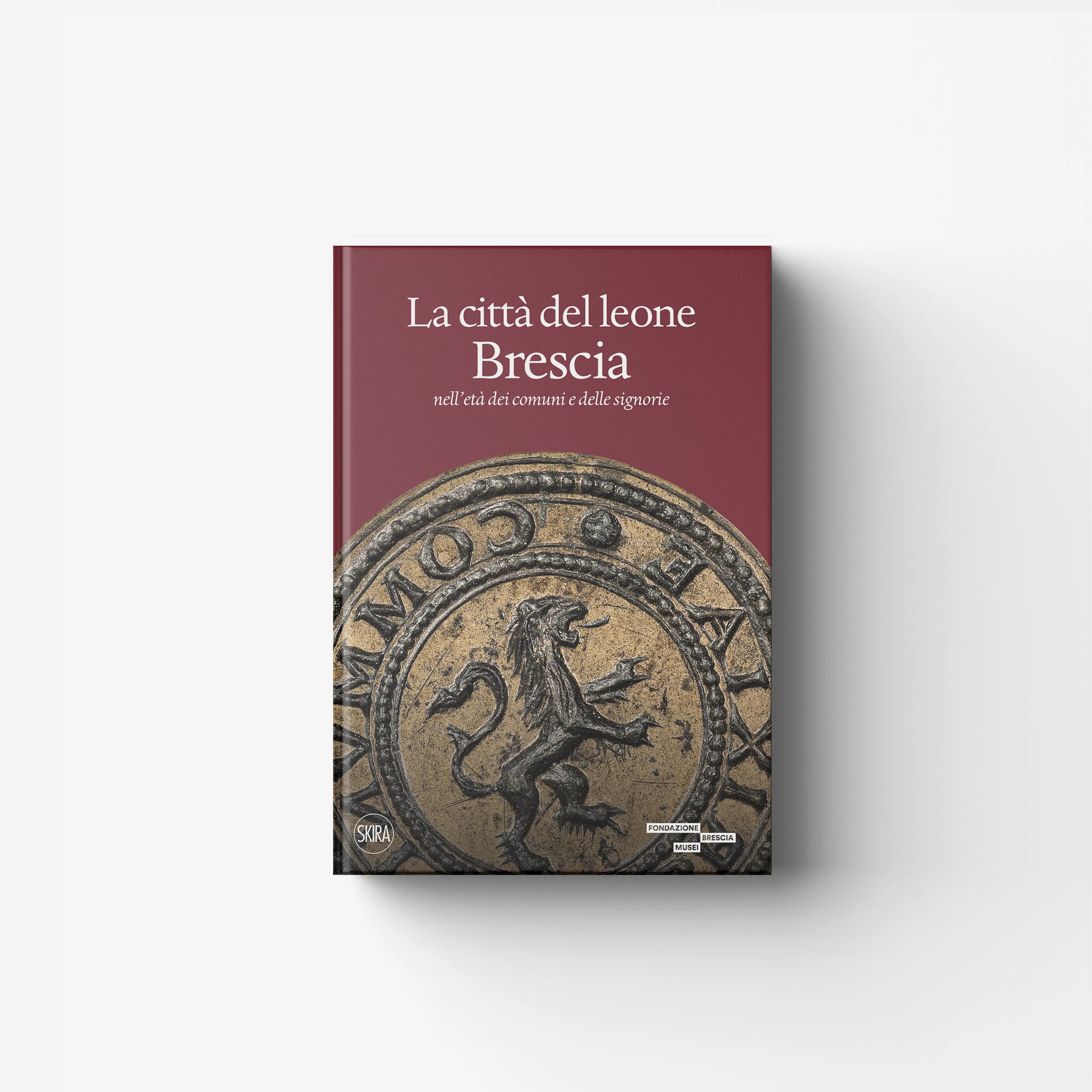 Historically illustrated book by Skira Arte with burgundy cover and lion medallion, on Brescia from the 12th century