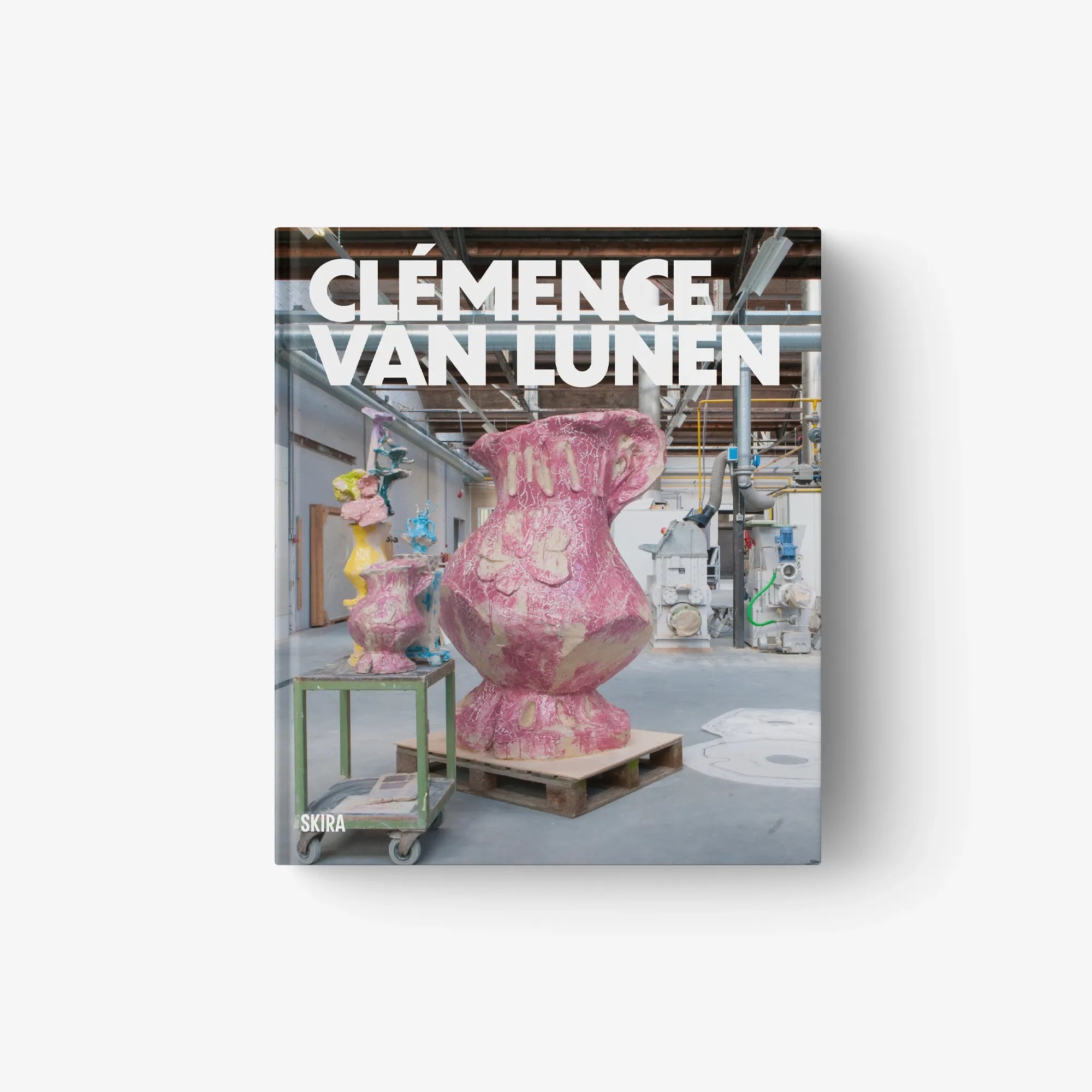 Hardcover art book with cover featuring a pink sculptural figure in a studio