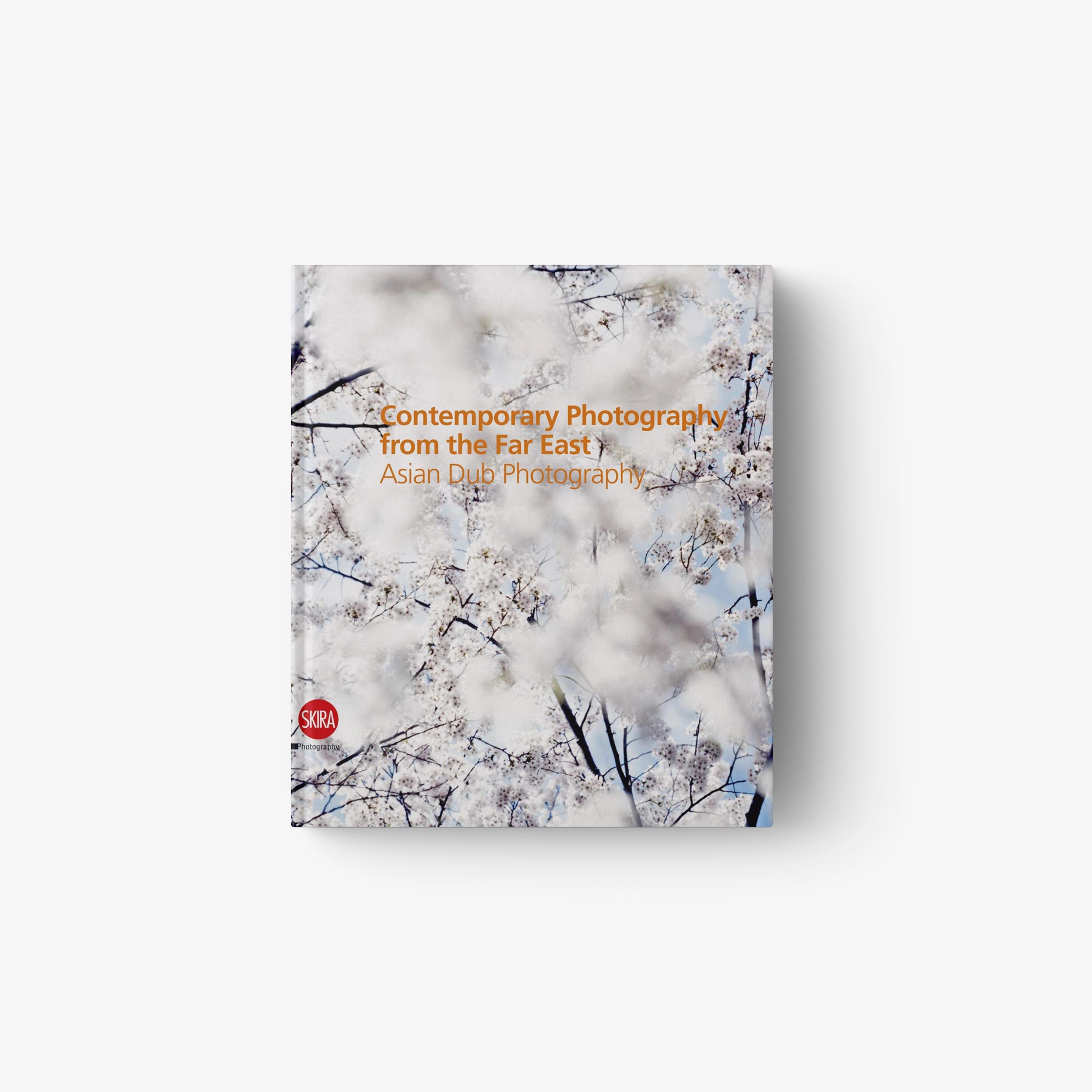 Paperback book with marble sky cover and tree branch illustration, red title text