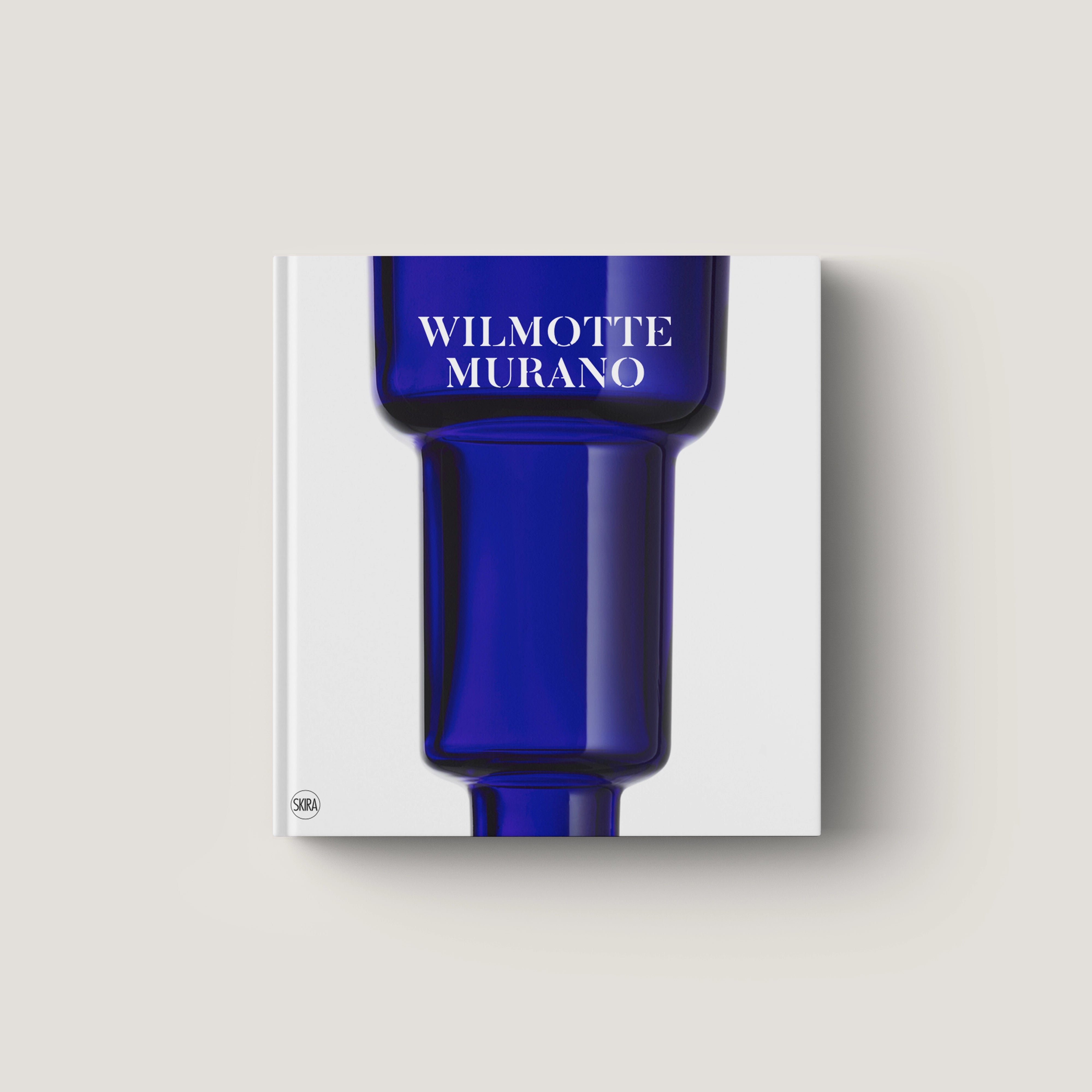 Square blue glass vase with a modern, tiered design and smooth finish on a white background.