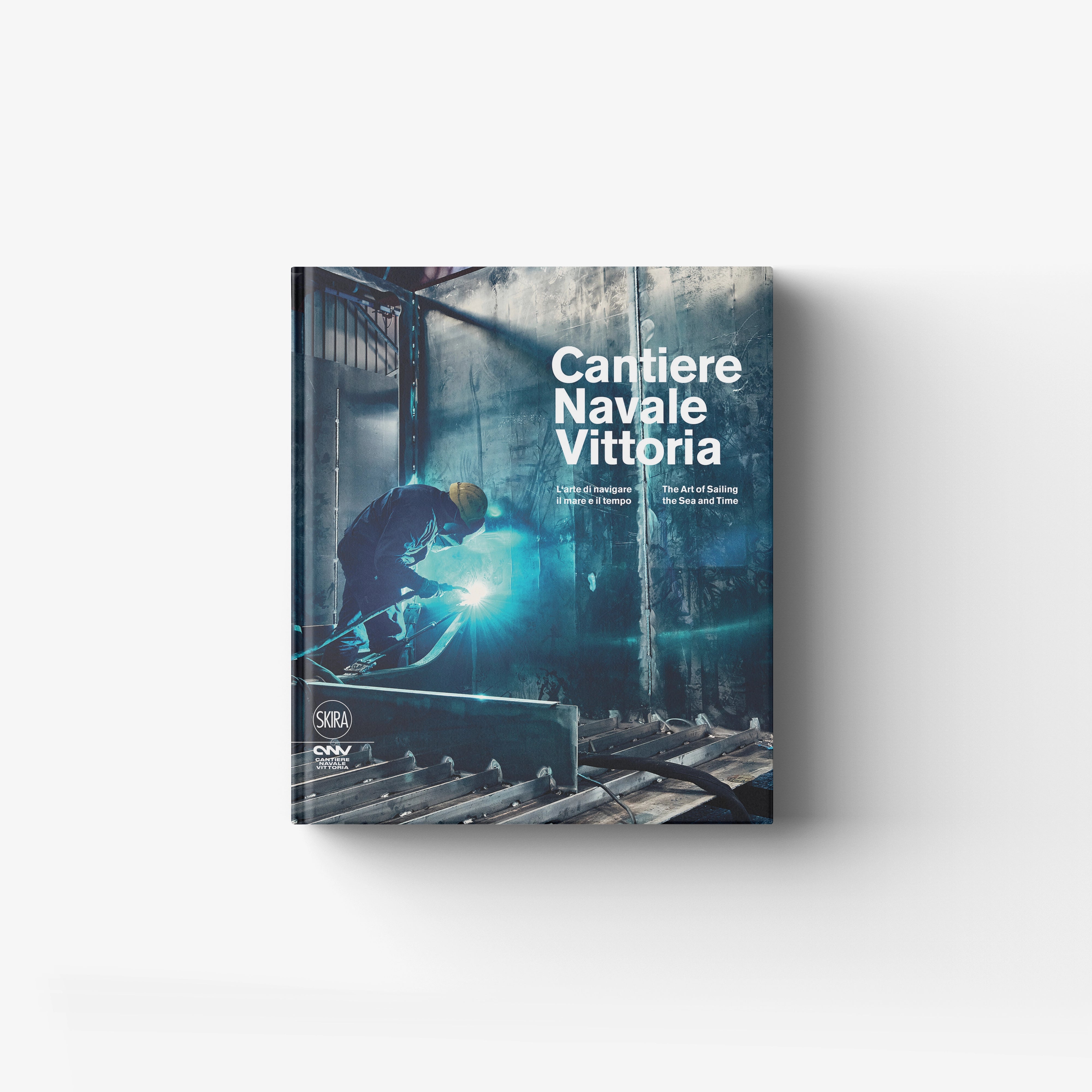 Hardback book in blue and teal with Skira Arte branding, featuring four generations of the Adria shipyard
