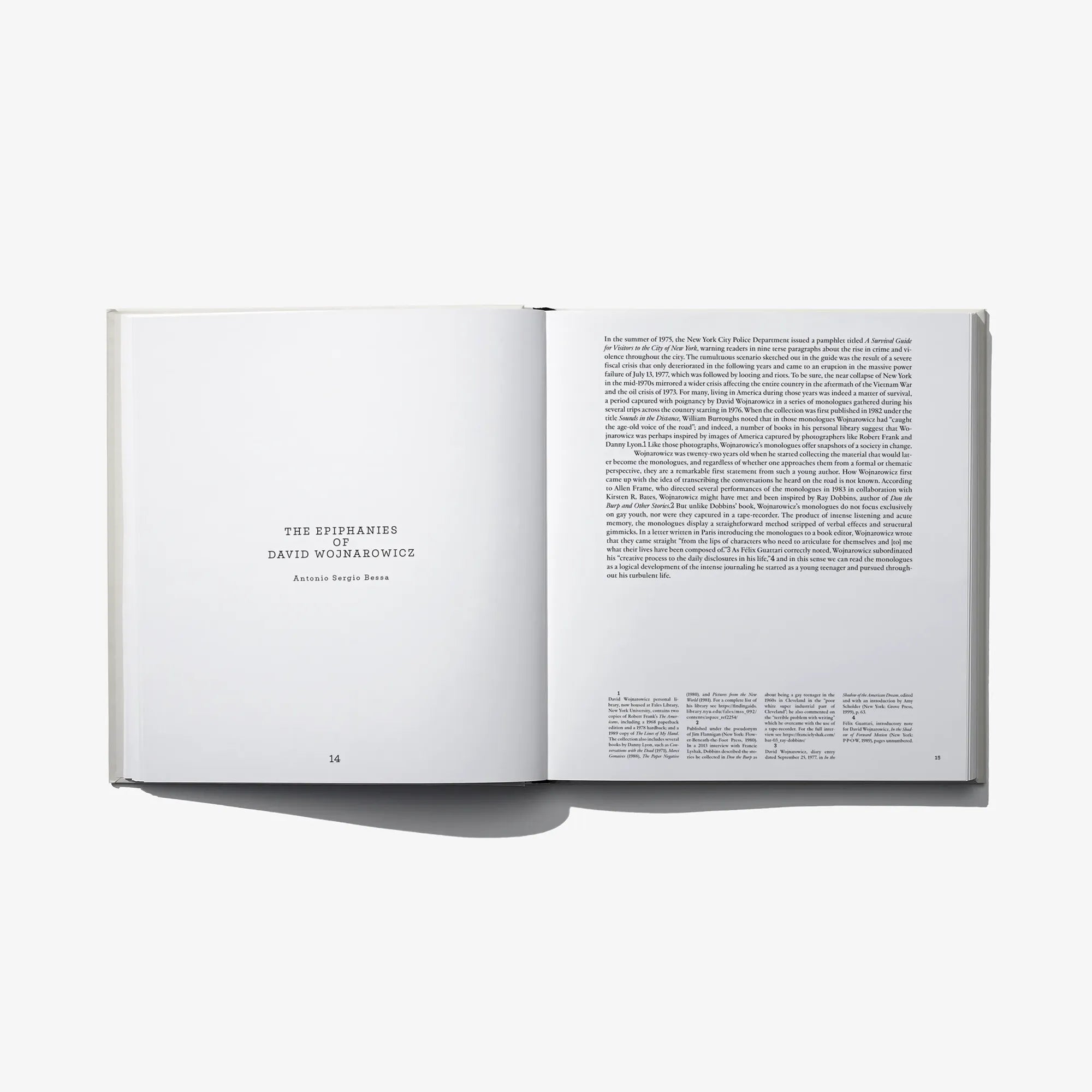 Open photo book with title on left page and dense paragraph text on right