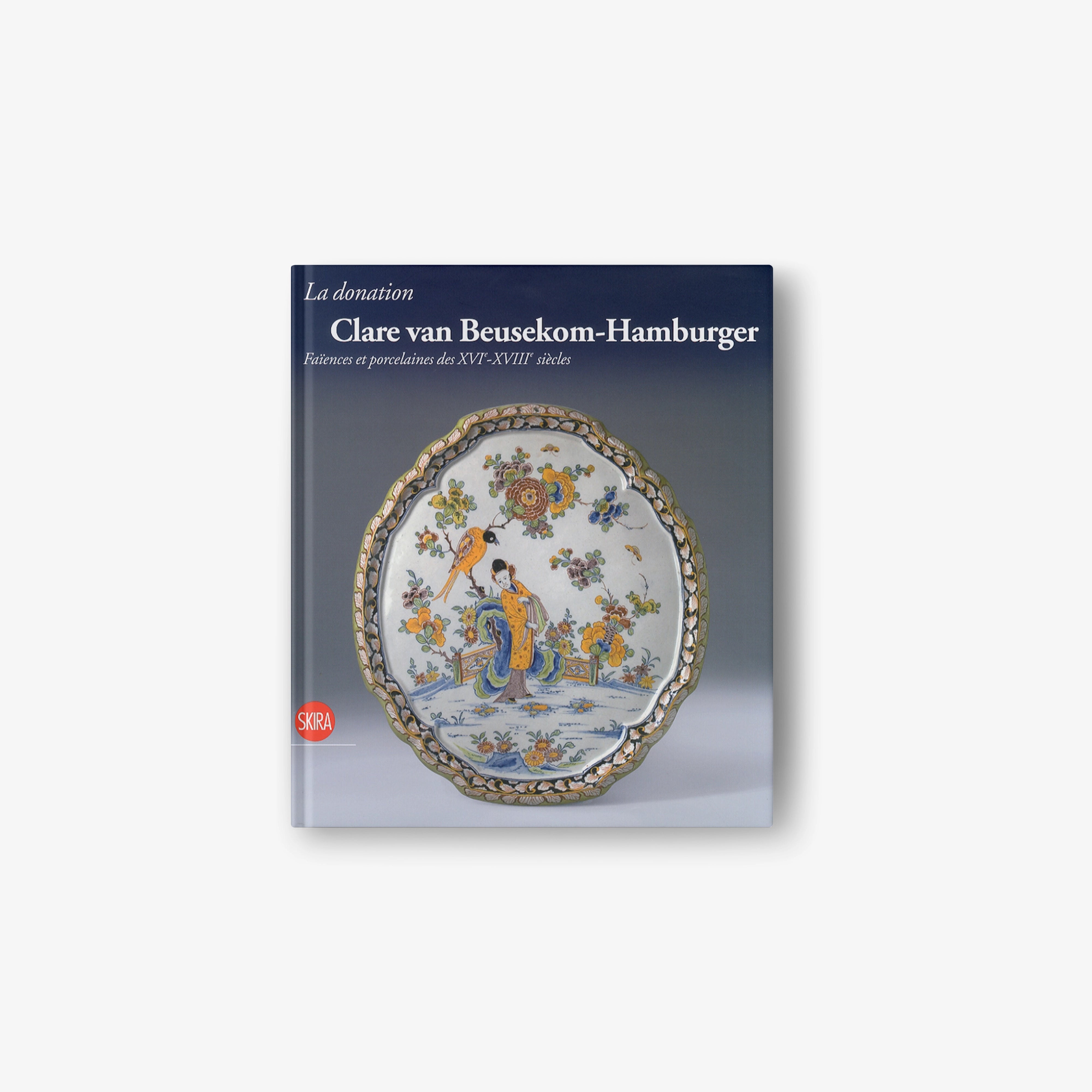 Hardcover art book with blue cover featuring painted porcelain plate illustration