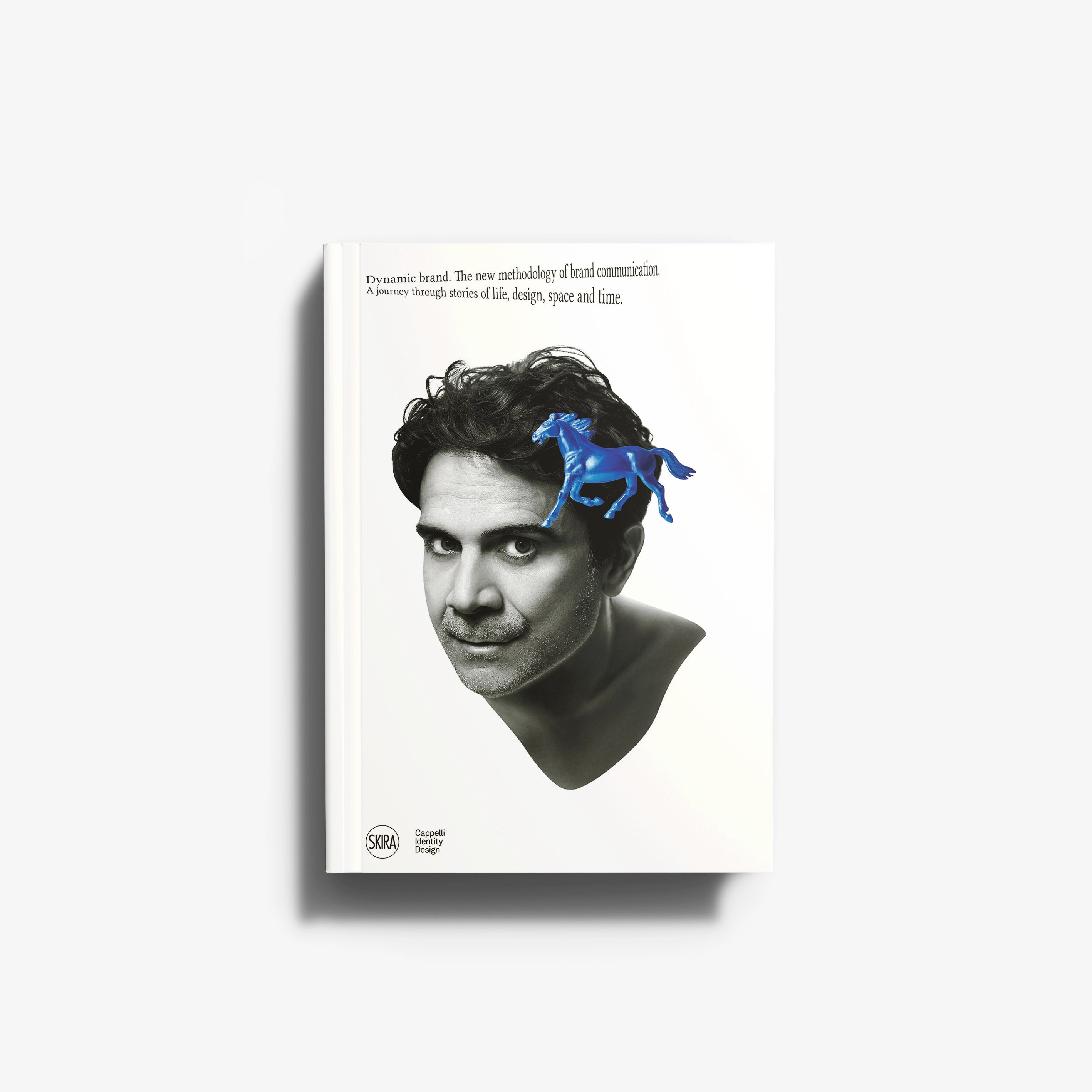 Design and communication book by Skira Arte with a blue horse on a black haired portrait cover