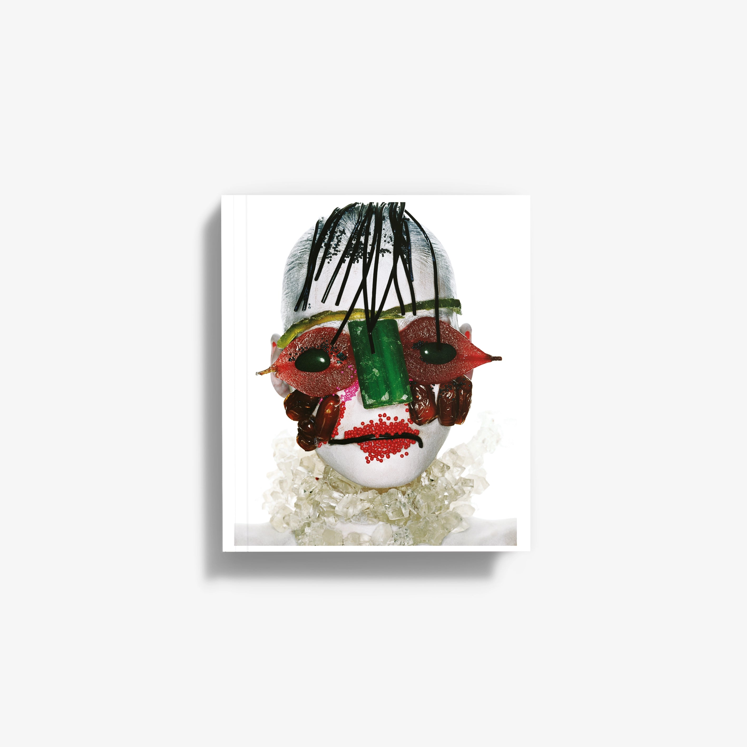 Softcover fashion art book with colorful face mask collage cover