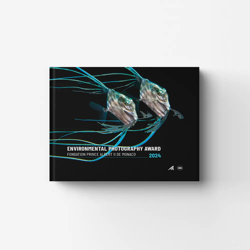 Hardcover photo book by Skira Arte with environmental photography award finalist images, showing two fish on a black cover