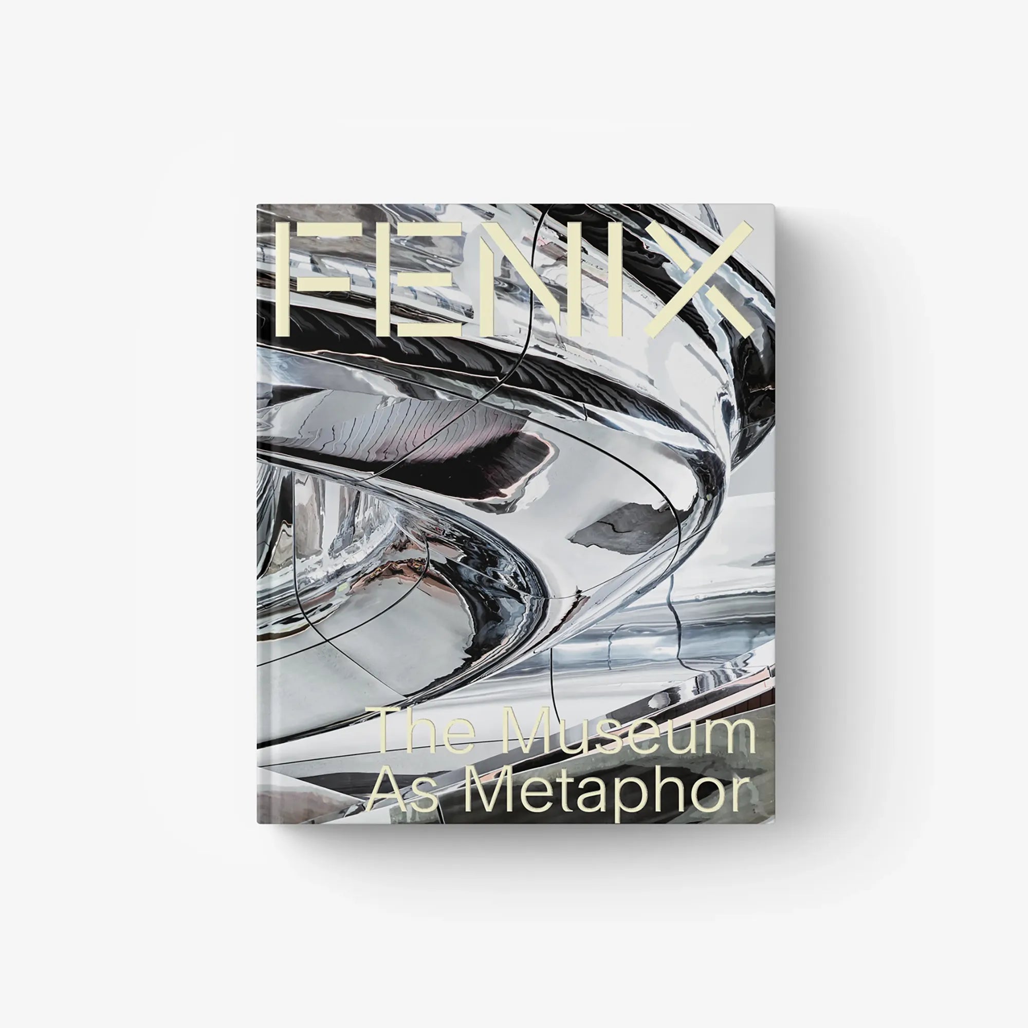 Architecture book with chrome-style abstract cover art and 'The Museum As Metaphor' text.