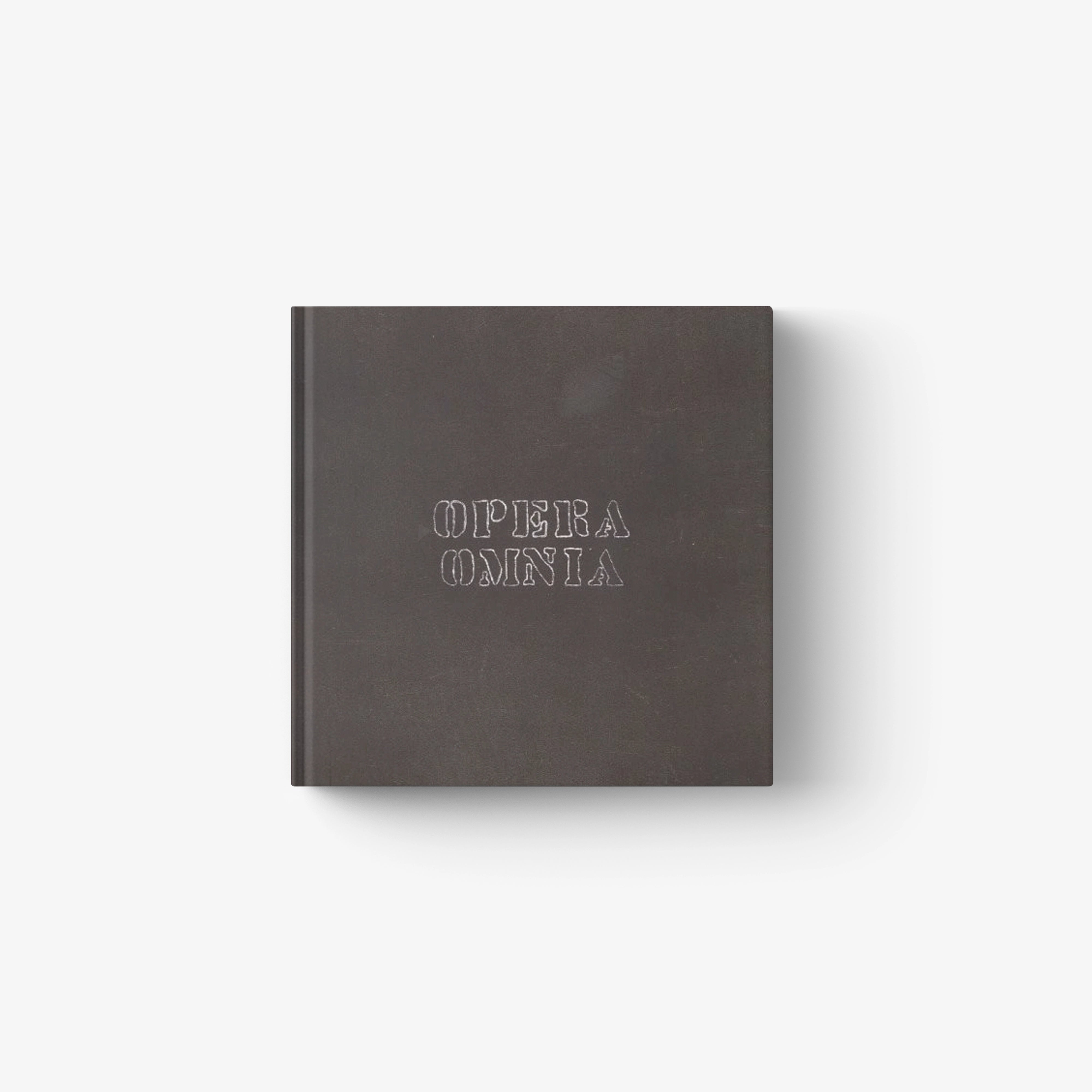 Hardcover book, dark gray cover with embossed 'OPERA OMNIA' text