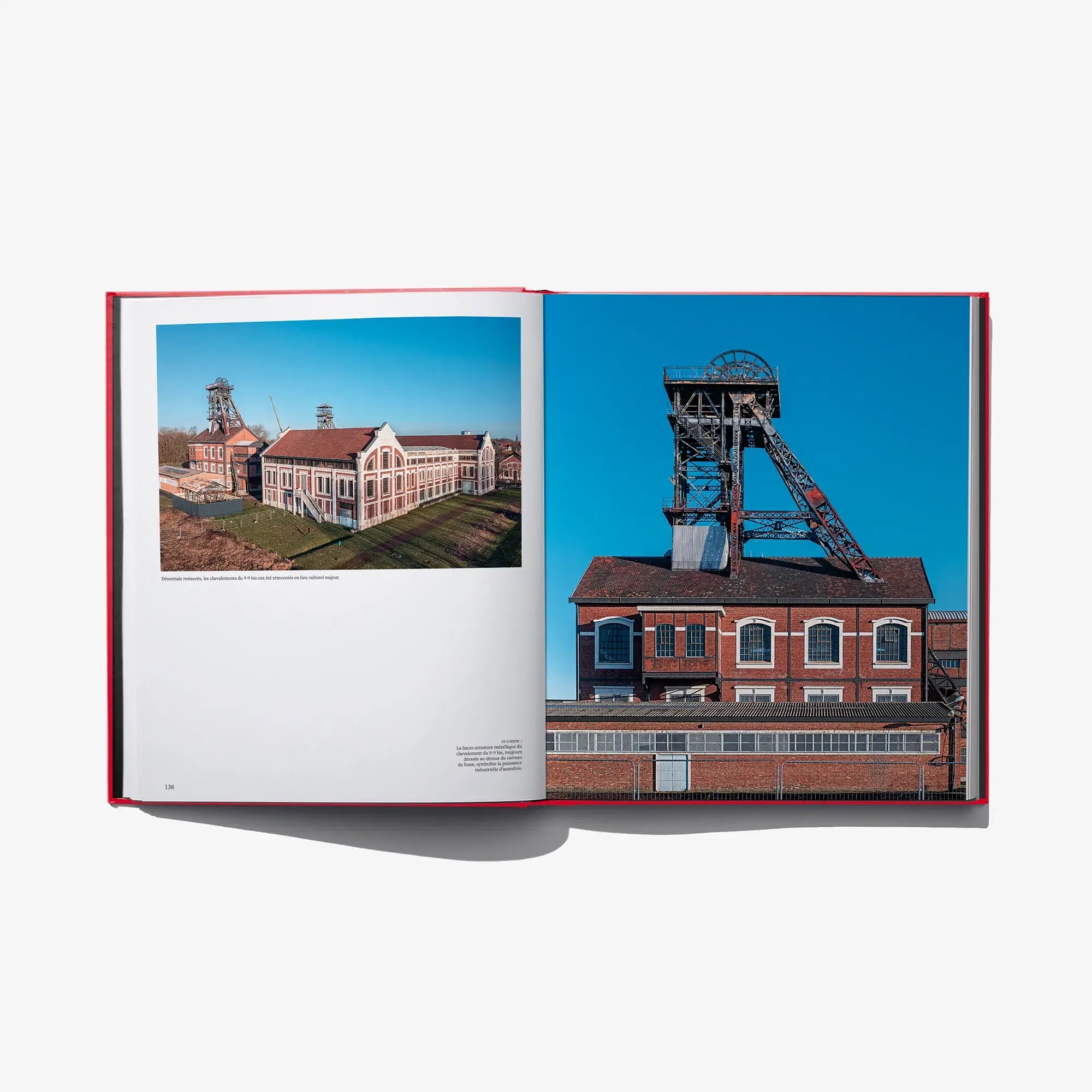 Open book spread featuring industrial building photo with blue sky