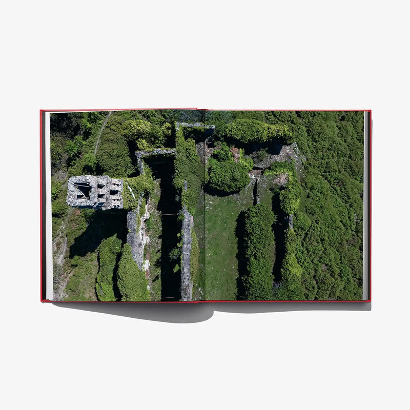 Aerial view photo on book page showing green grounds and stone ruins
