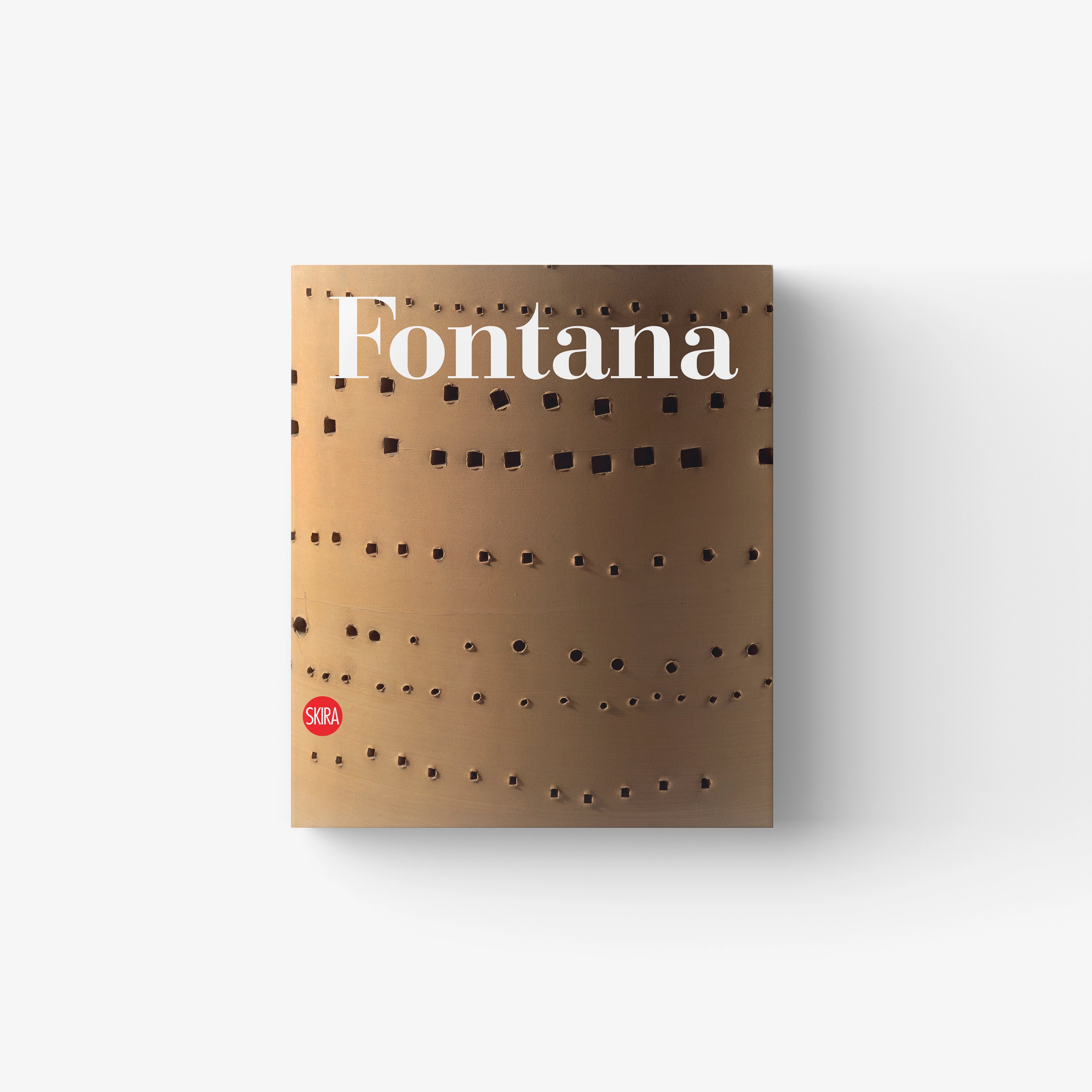 Art catalogue book in tan with cut-out pattern and Lucio Fontana title, published by Skira Arte, catalogo ragionato di sculture ceramiche