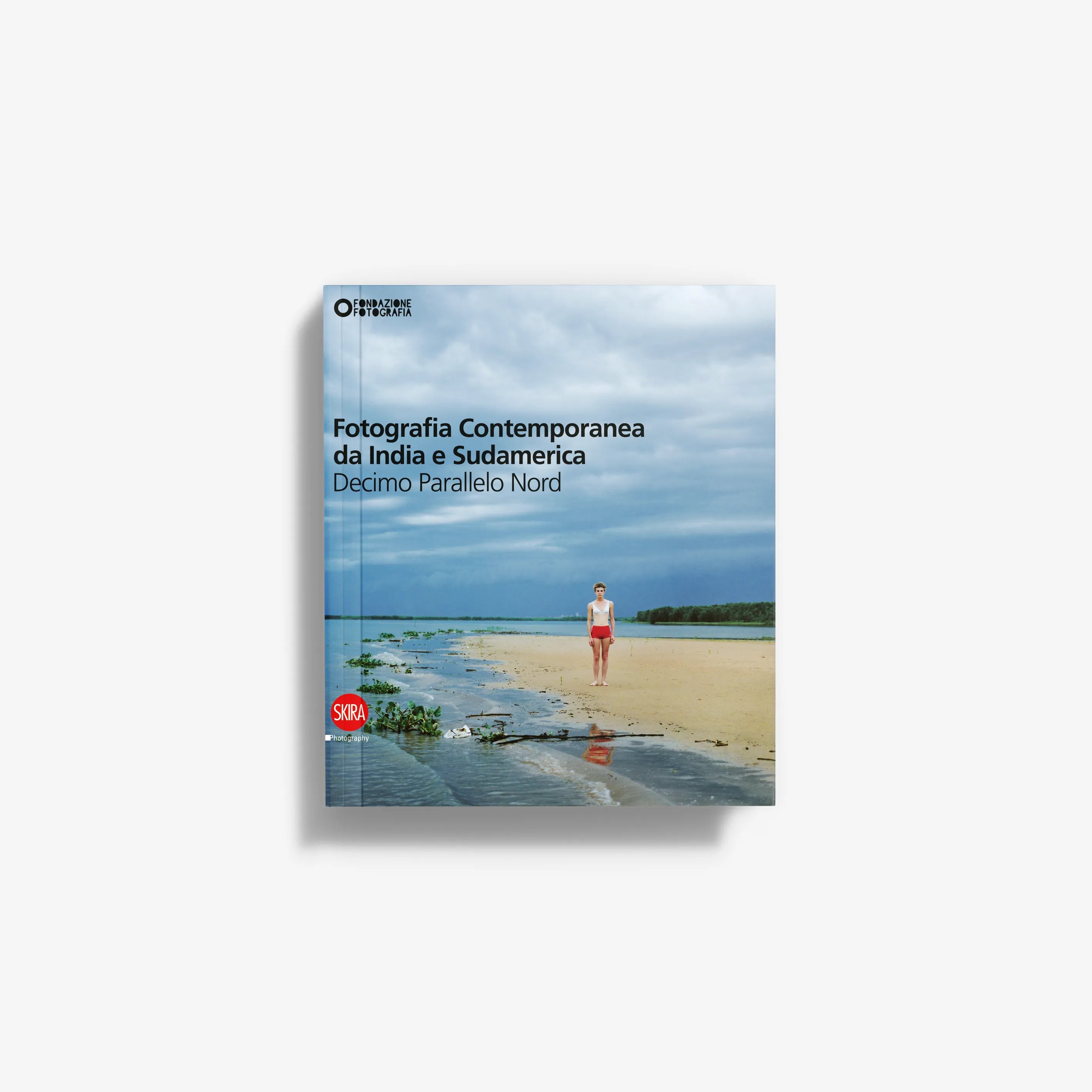 Contemporary photography book cover with beach, sky-blue background, and person in red shorts.