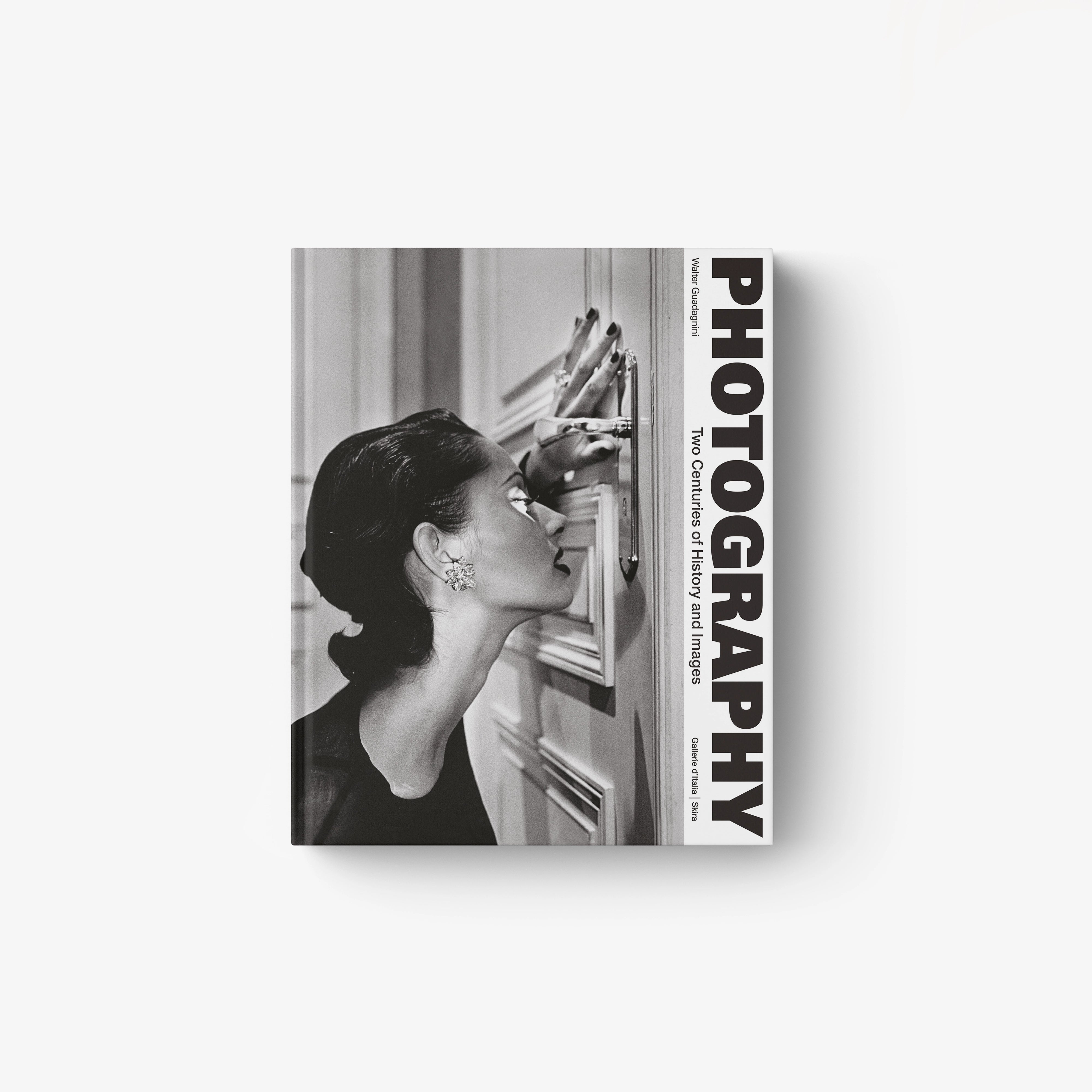 Black and white cover showing woman looking through vintage camera lens with bold vertical "PHOTOGRAPHY" text.