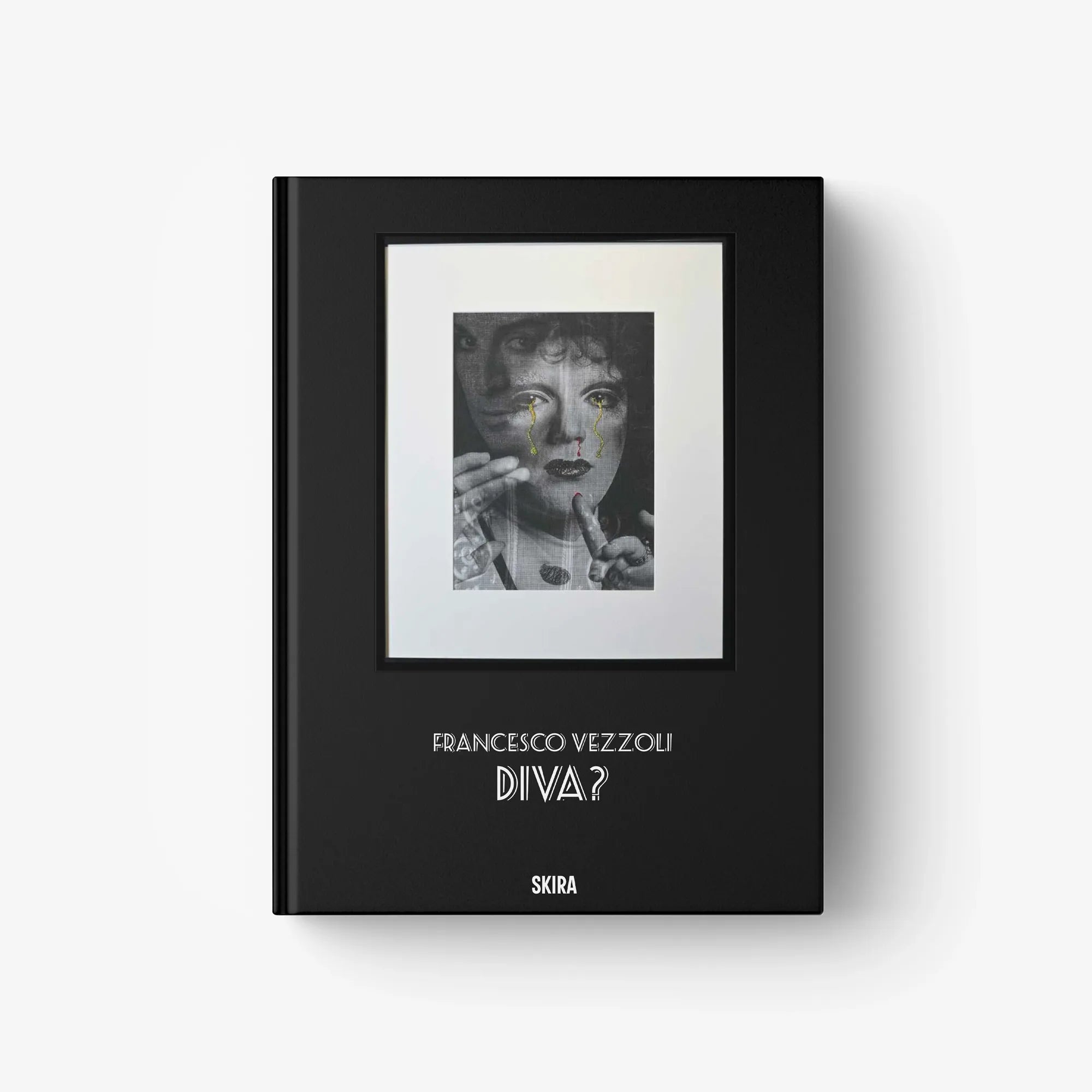 Black hardcover art book with framed portrait print and title text