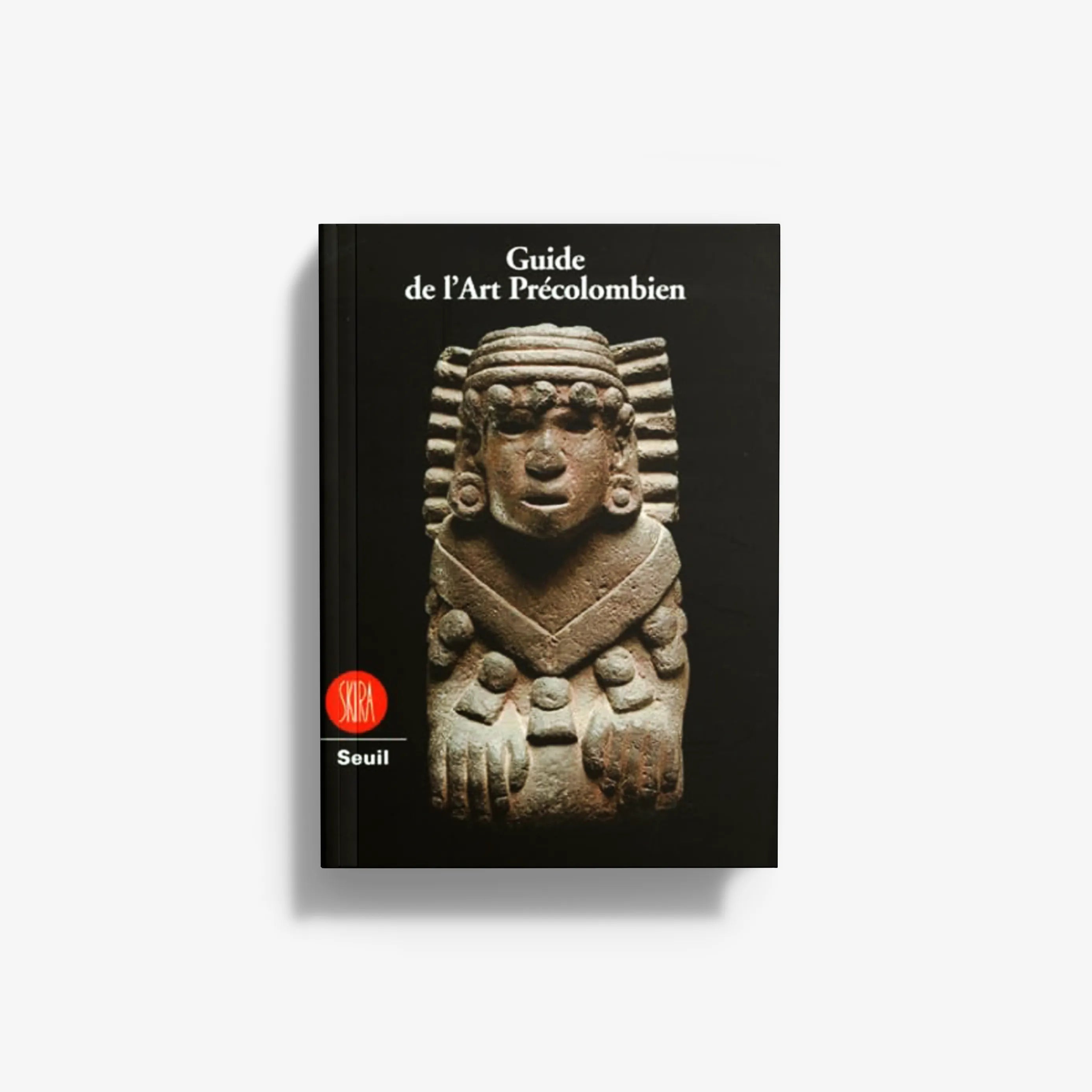 Pre-Columbian art guidebook with black cover and gold sculpted face artwork