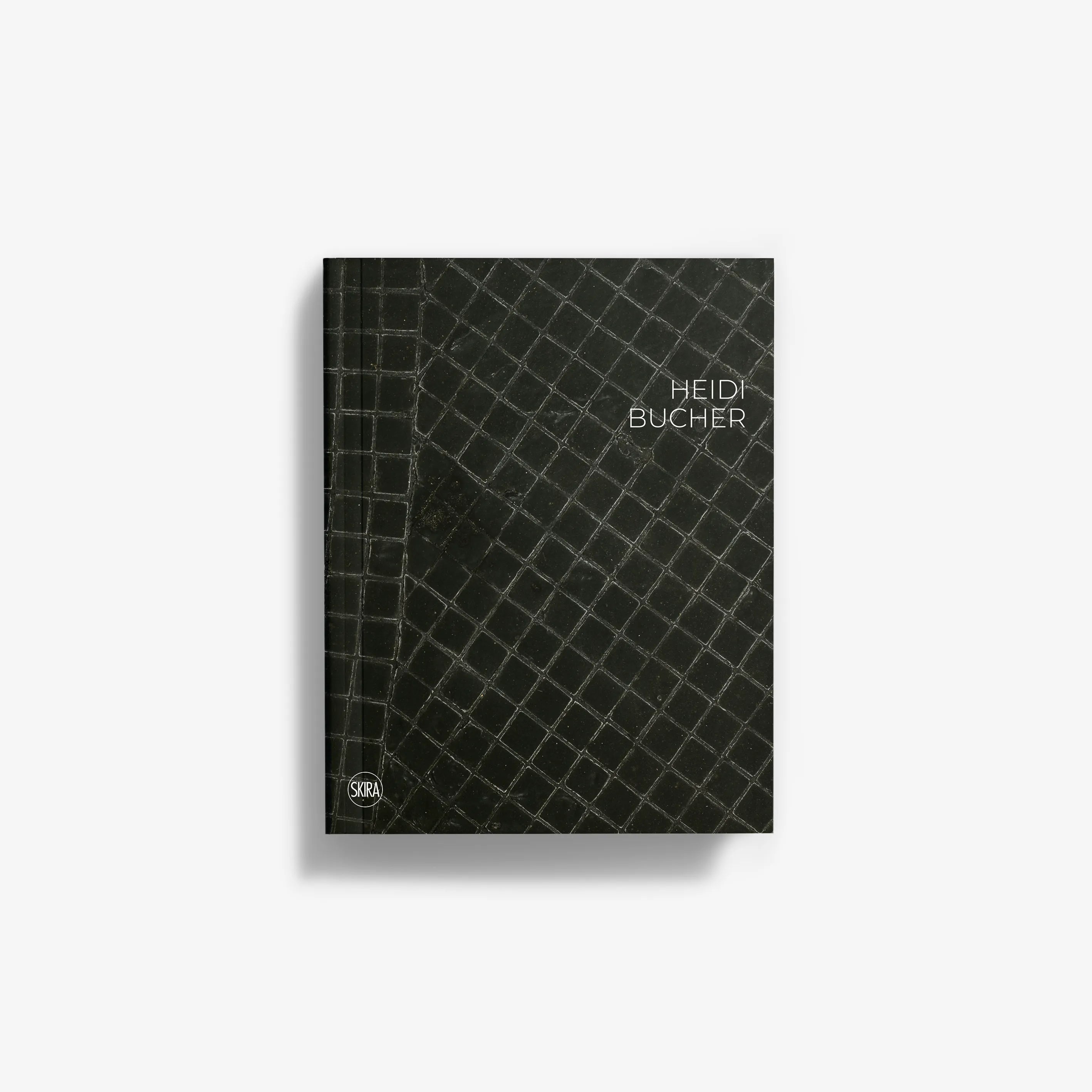Hardcover book cover with dark crocodile-textured pattern and Heidi Bucher title