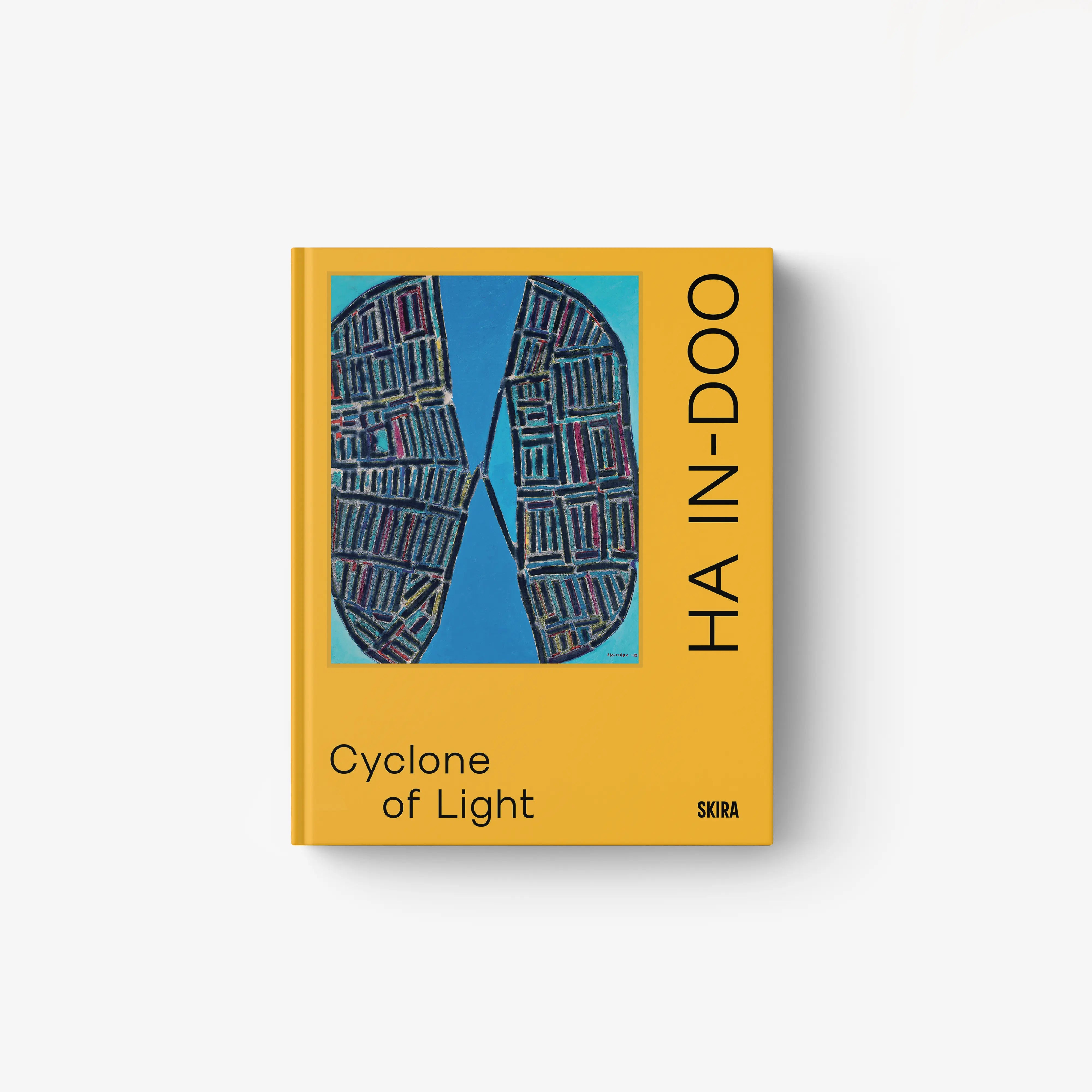 Hardcover art book with yellow cover, blue architectural graphic, title Cyclone of Light