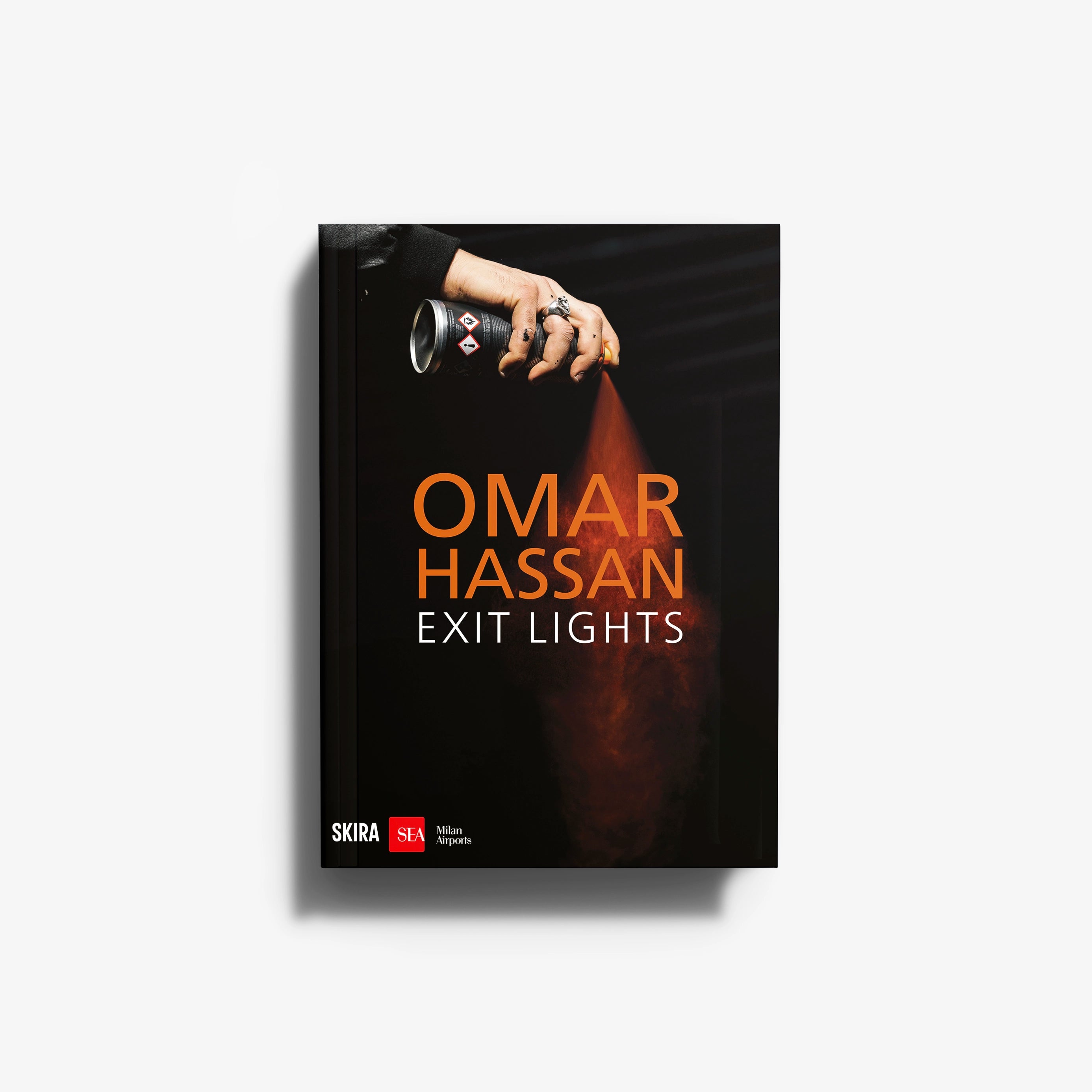 Contemporary exit lights installation by Skira Arte with video integrated, showing a hand holding a black can