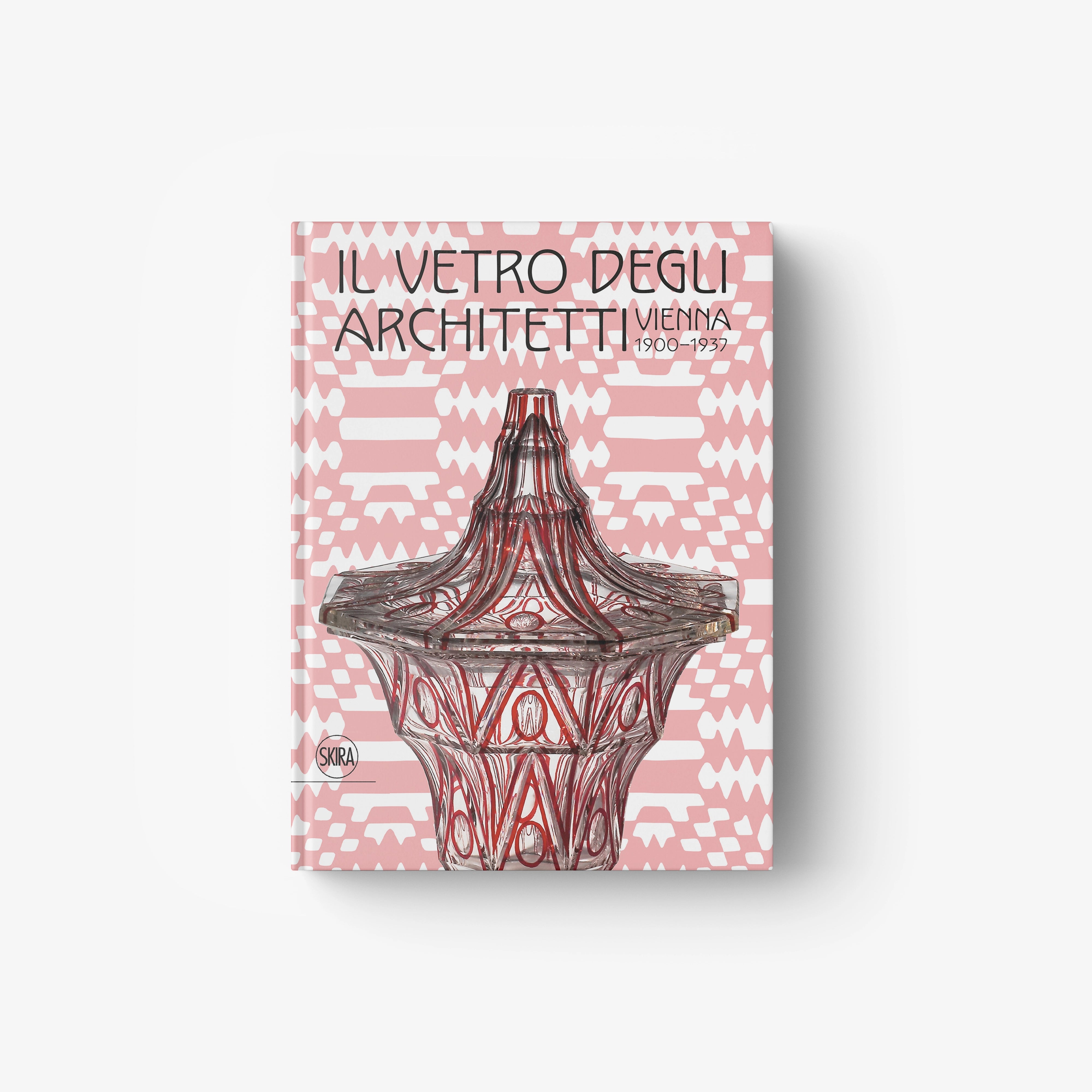 Ornate dark glass-style emblem on pink geometric book cover