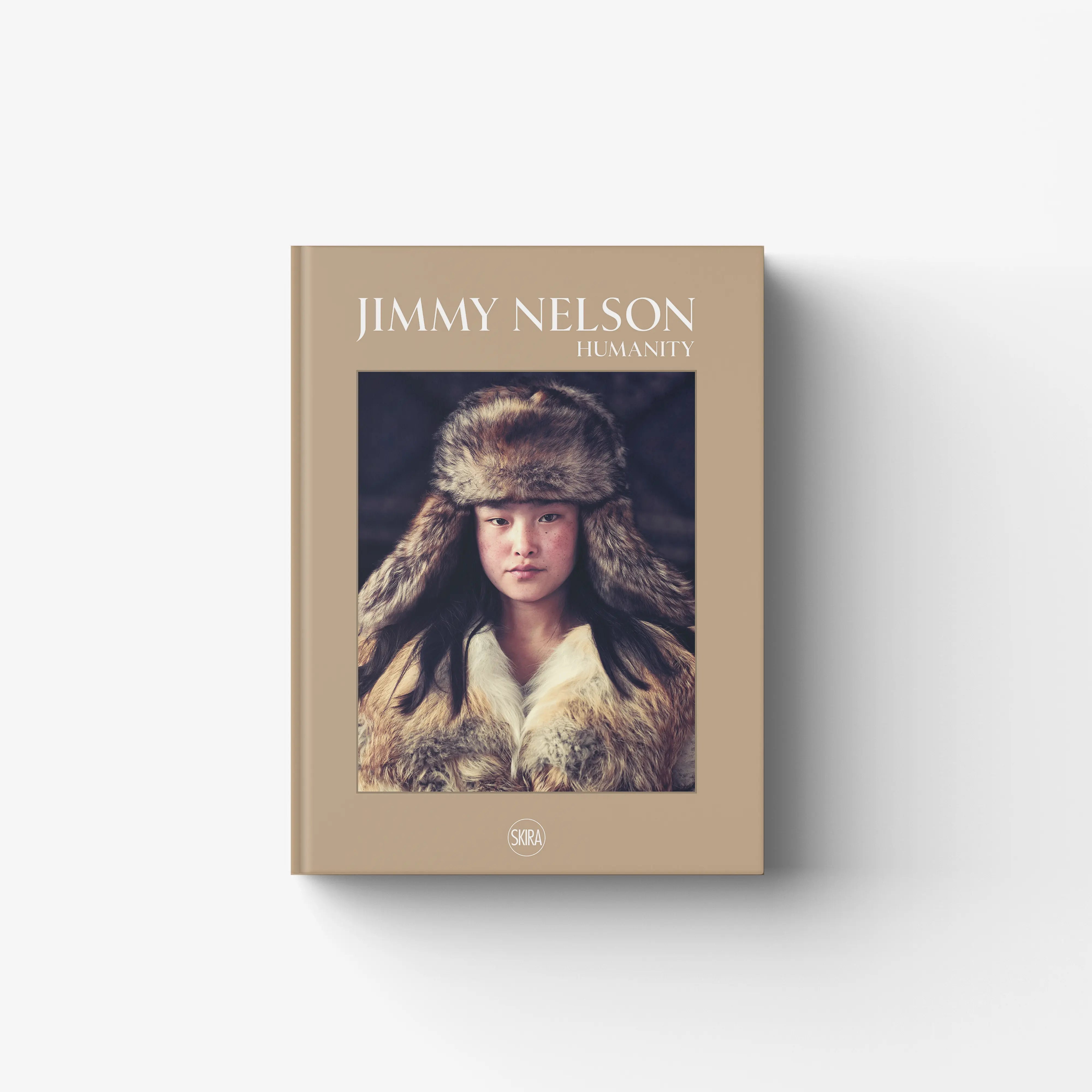 Photo book in beige with Jimmy Nelson Humanity cover by Skira Arte, Italian edition, volume with large 10x8 negatives
