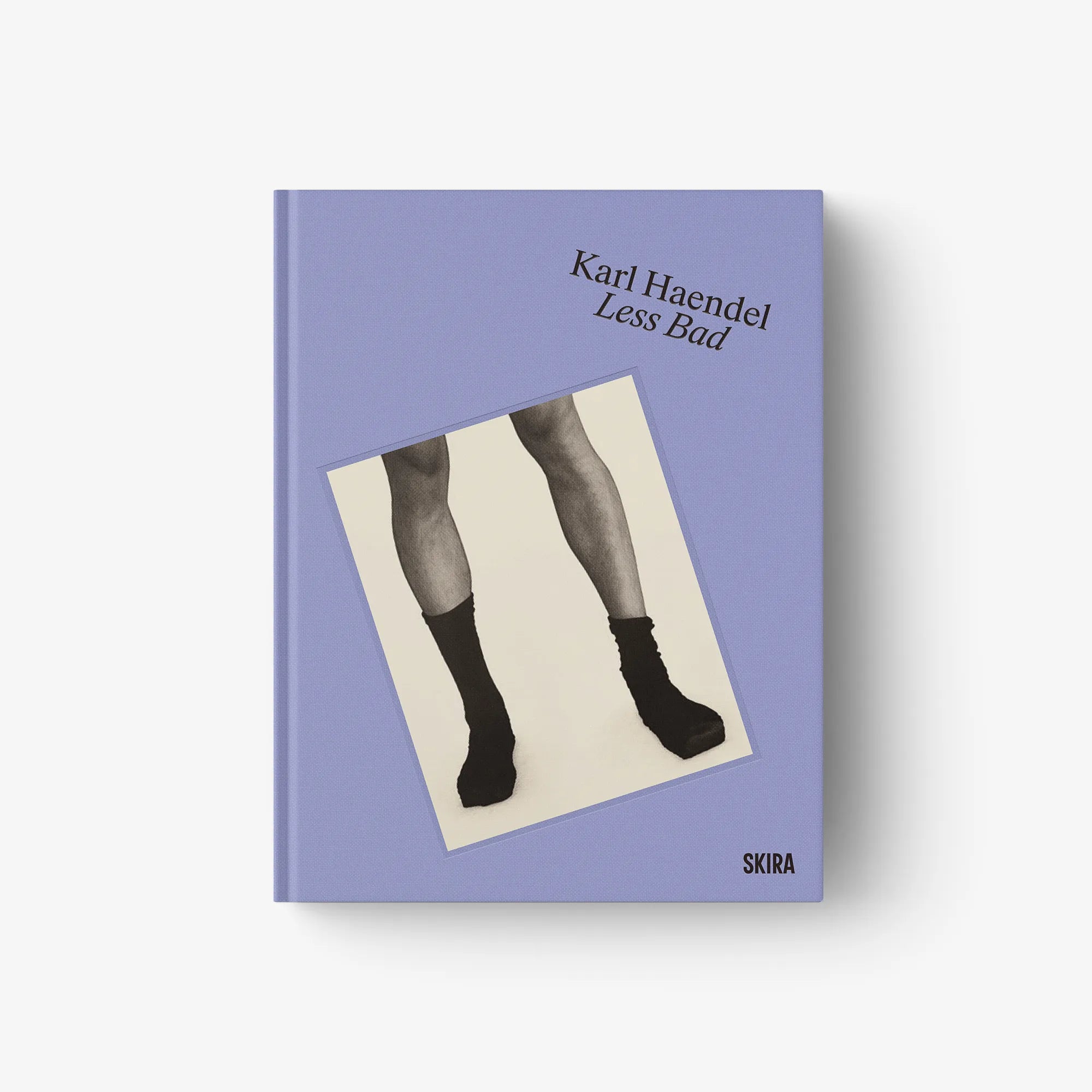 Purple art book cover with black title text and photo of legs in socks