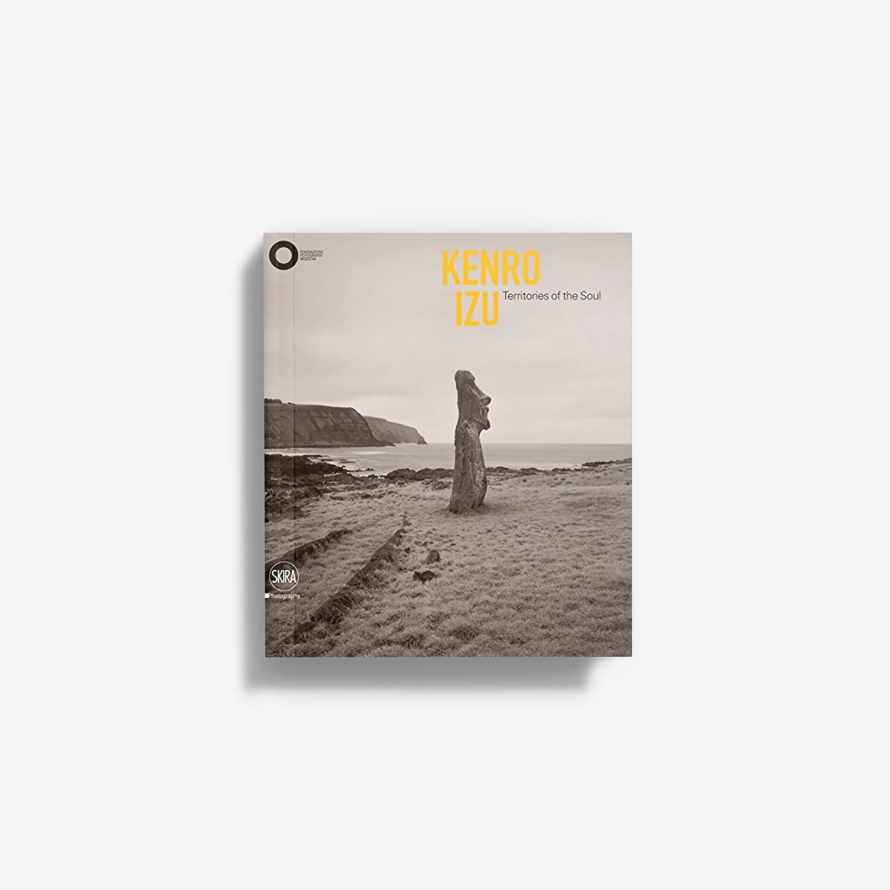 Photo book cover with sepia beach landscape, standing figure, and title text: Kenro Izu