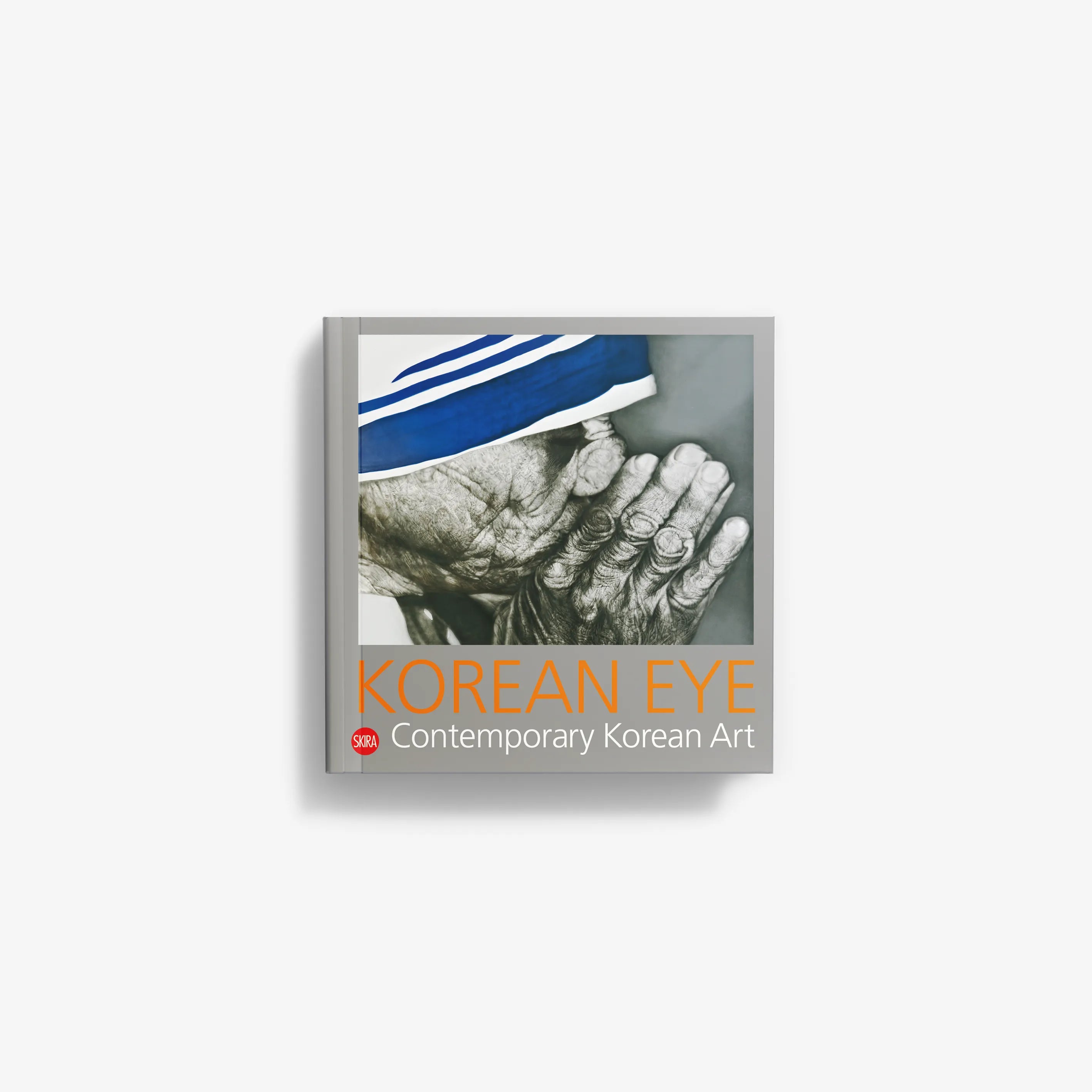 Contemporary Korean art book cover with hands, blue cloth, and printed title