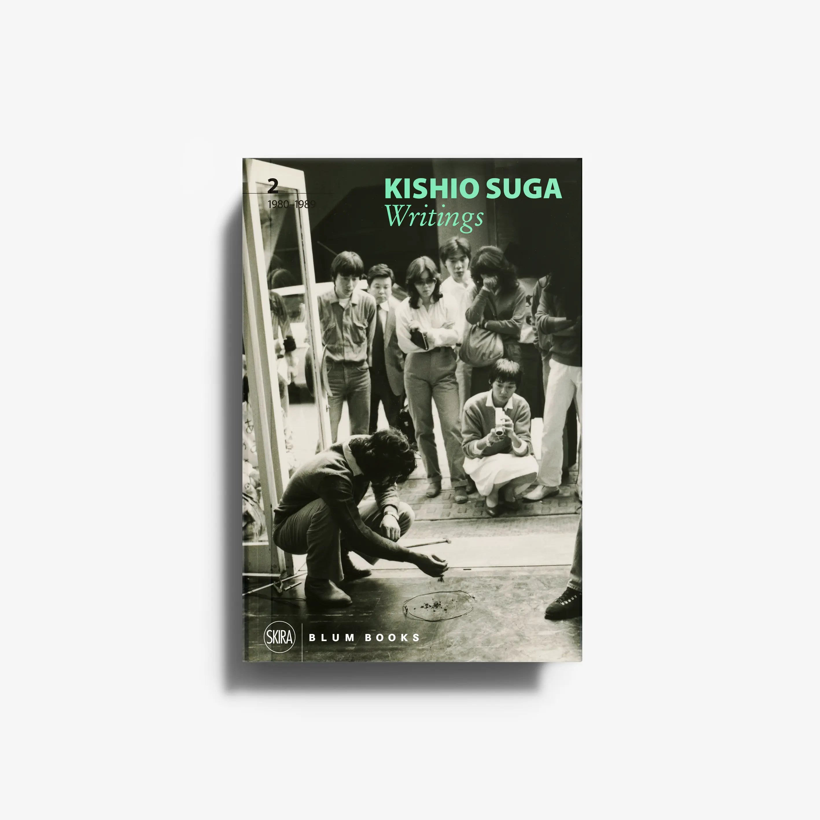 Art book by Skira Arte, Kishio Suga Writings Volume II, with monochrome group photo and green title text