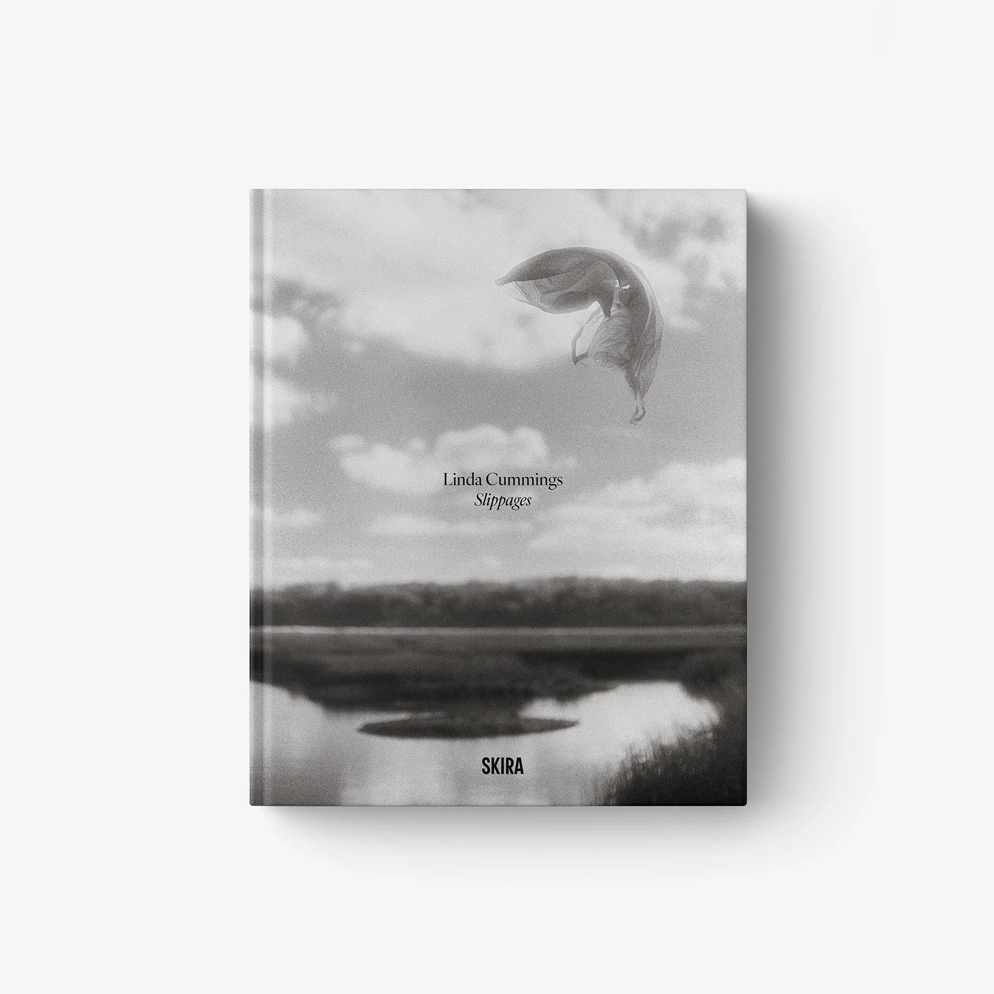 Slippages photo book cover with grayscale sky and bird-like figure; SKIRA