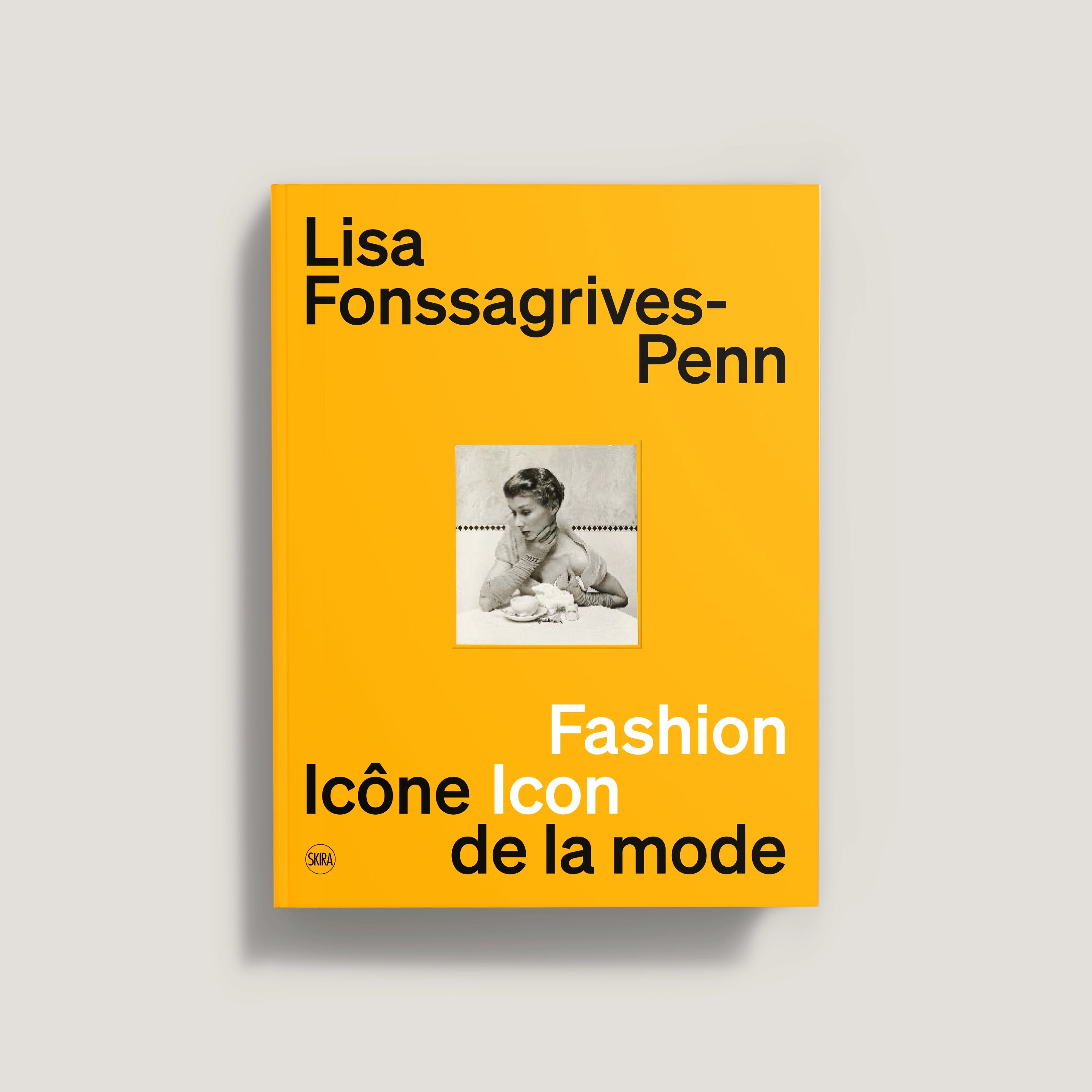 Bright orange book cover with black and white photo of a woman, titled Lisa Fonssagrives-Penn Fashion Icon.