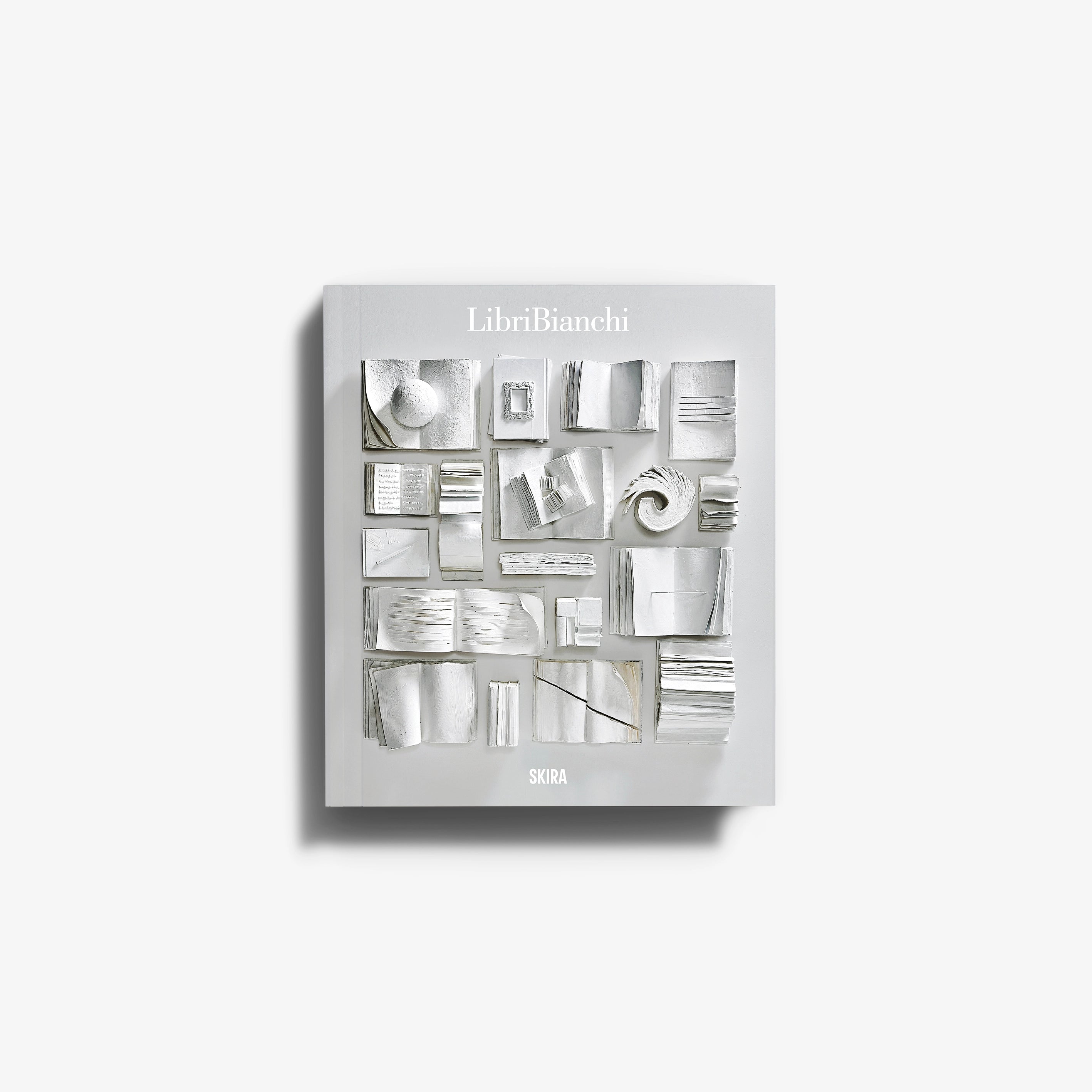 Contemporary art installation by Skira Arte, white plaster covered books arranged in a sculptural display