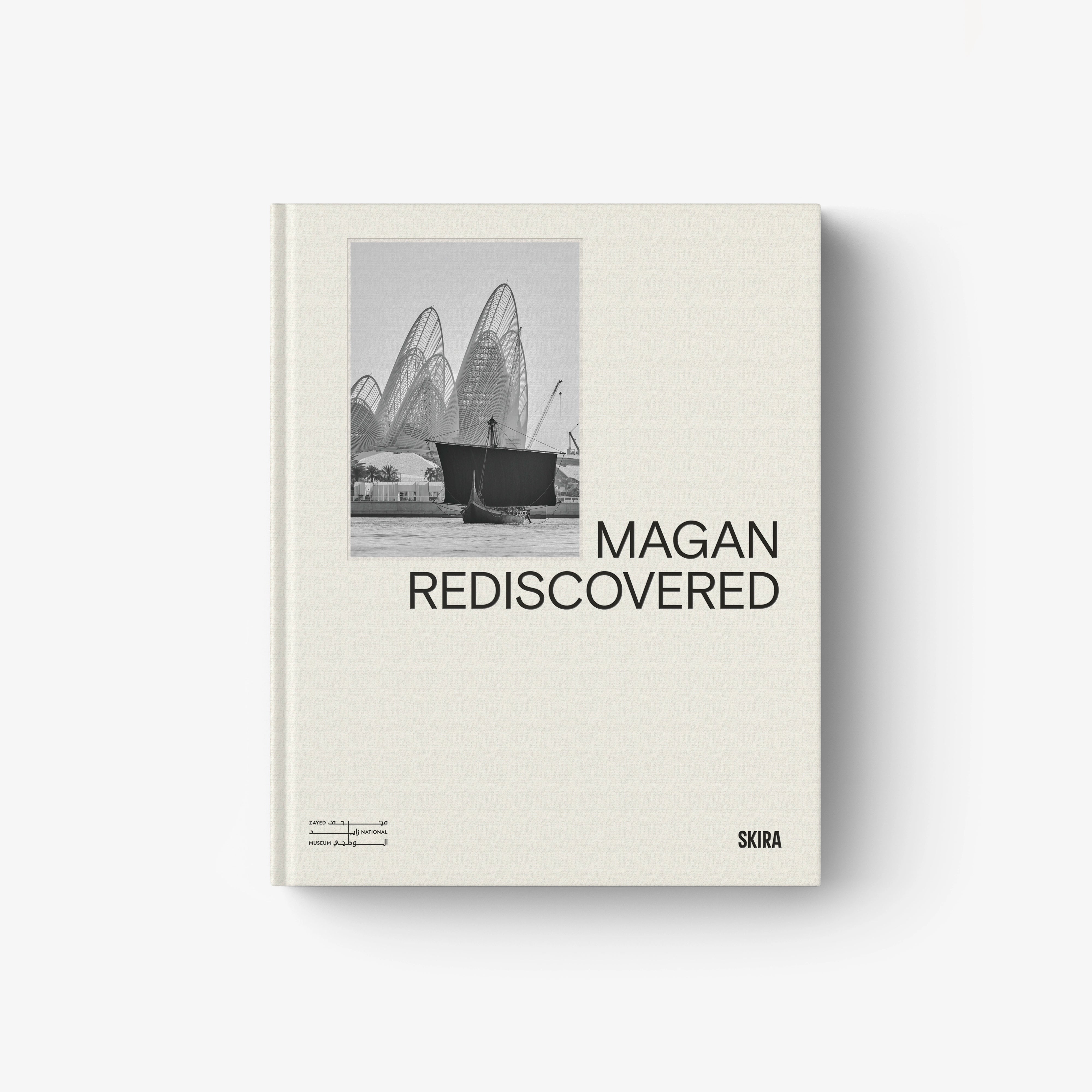 Hardcover book with beige cover, MAGAN REDISCOVERED title, and boat photo