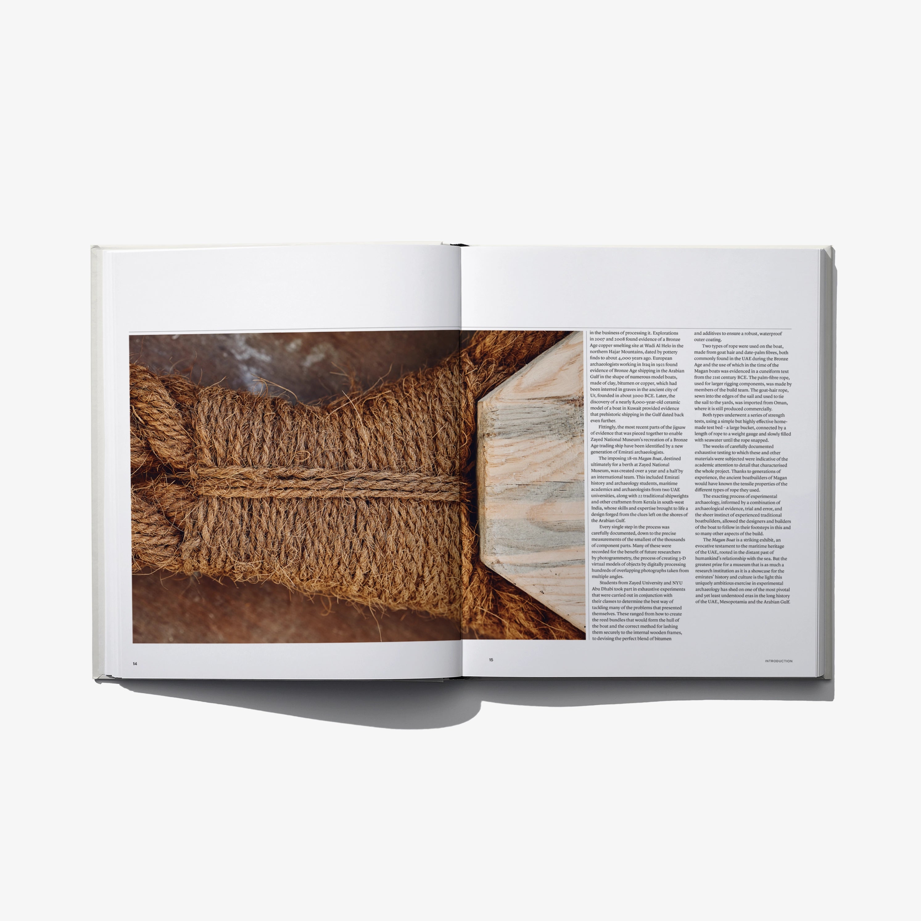 Open book spread showing close-up woven rope and columns of printed text