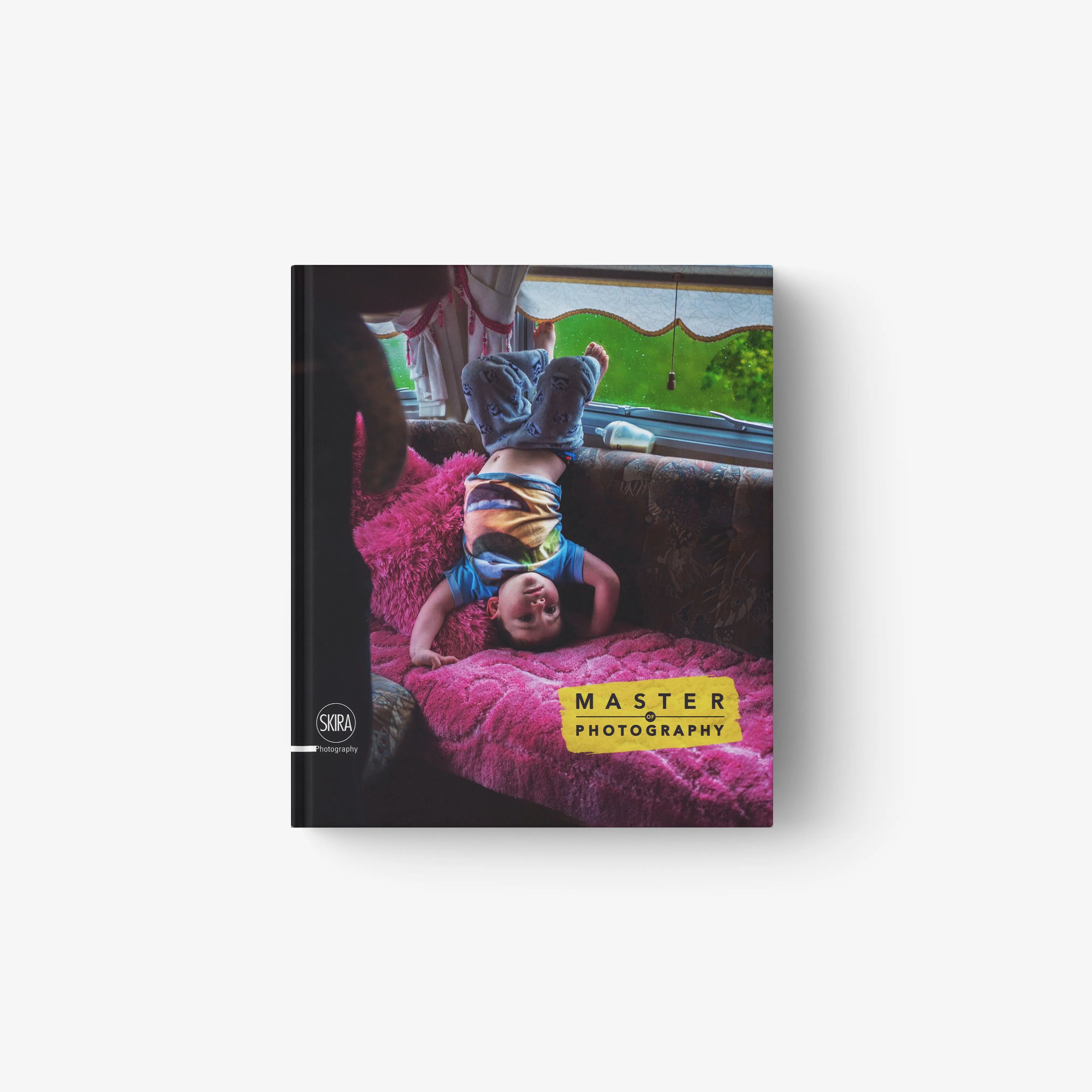 Hardcover photo book in colour by Skira Arte, Master of Photography 2017, showing a child on a bright pink rug